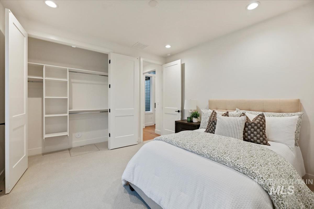 Bedroom with recessed lighting, a closet, and light carpet