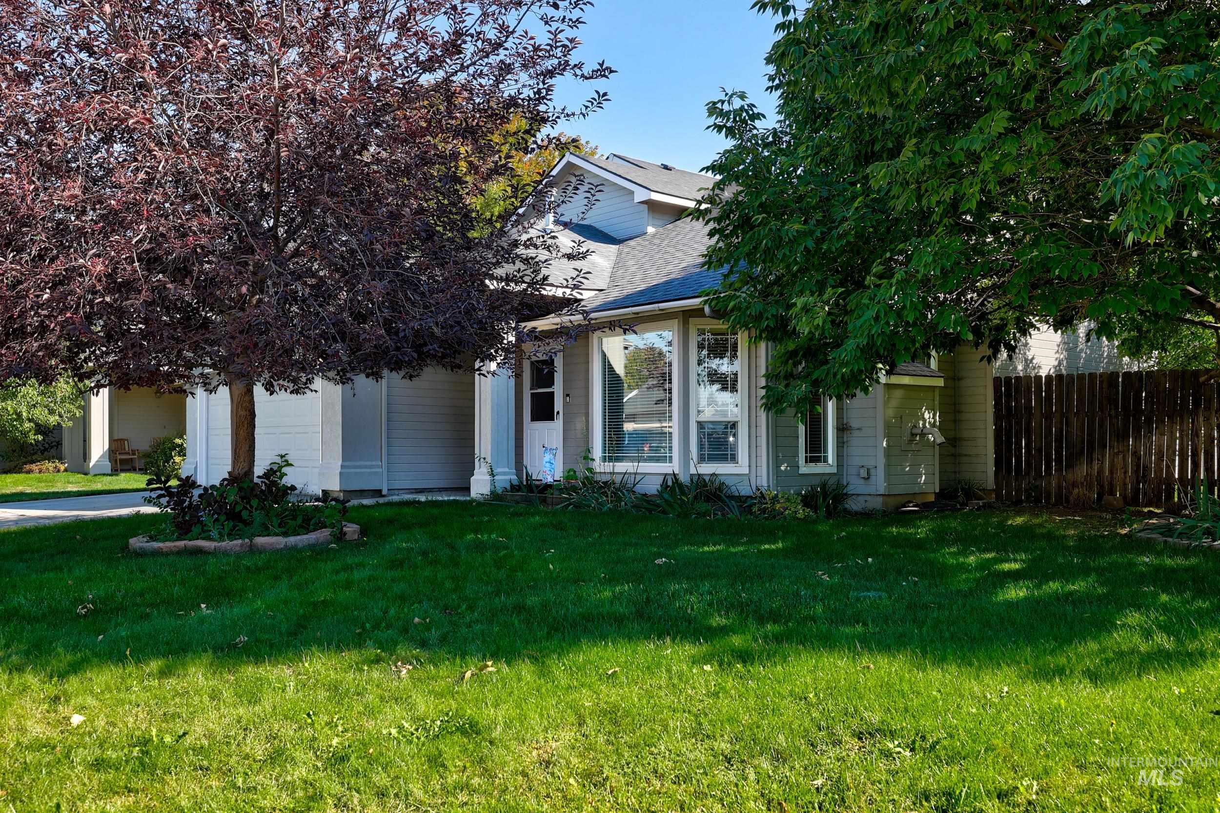 Obstructed view of property with a garage, roof with shingles, and concrete driveway