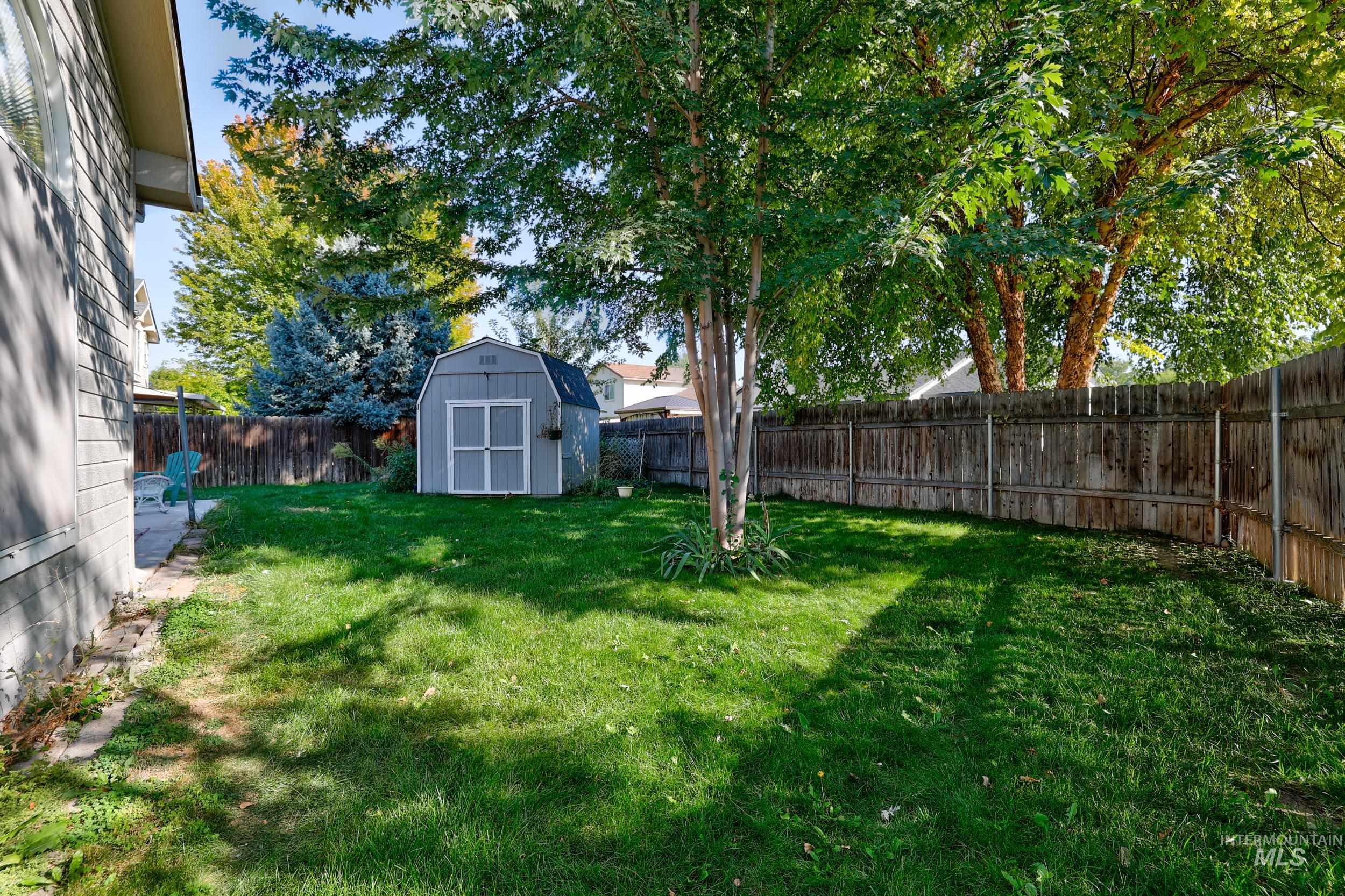 Fenced backyard with a shed