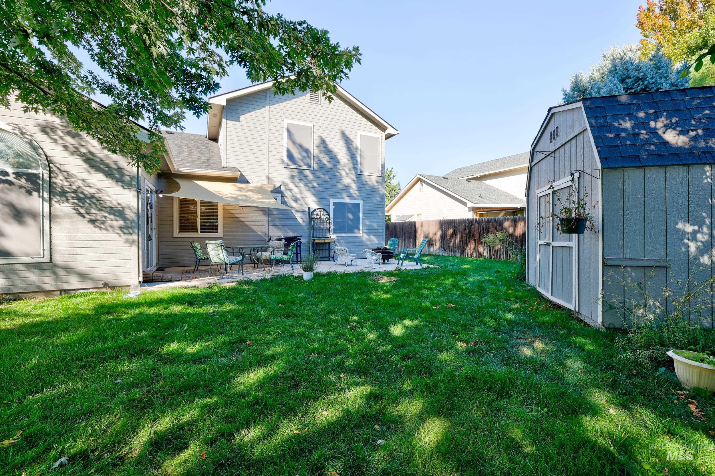 View of yard with a patio area and a storage unit
