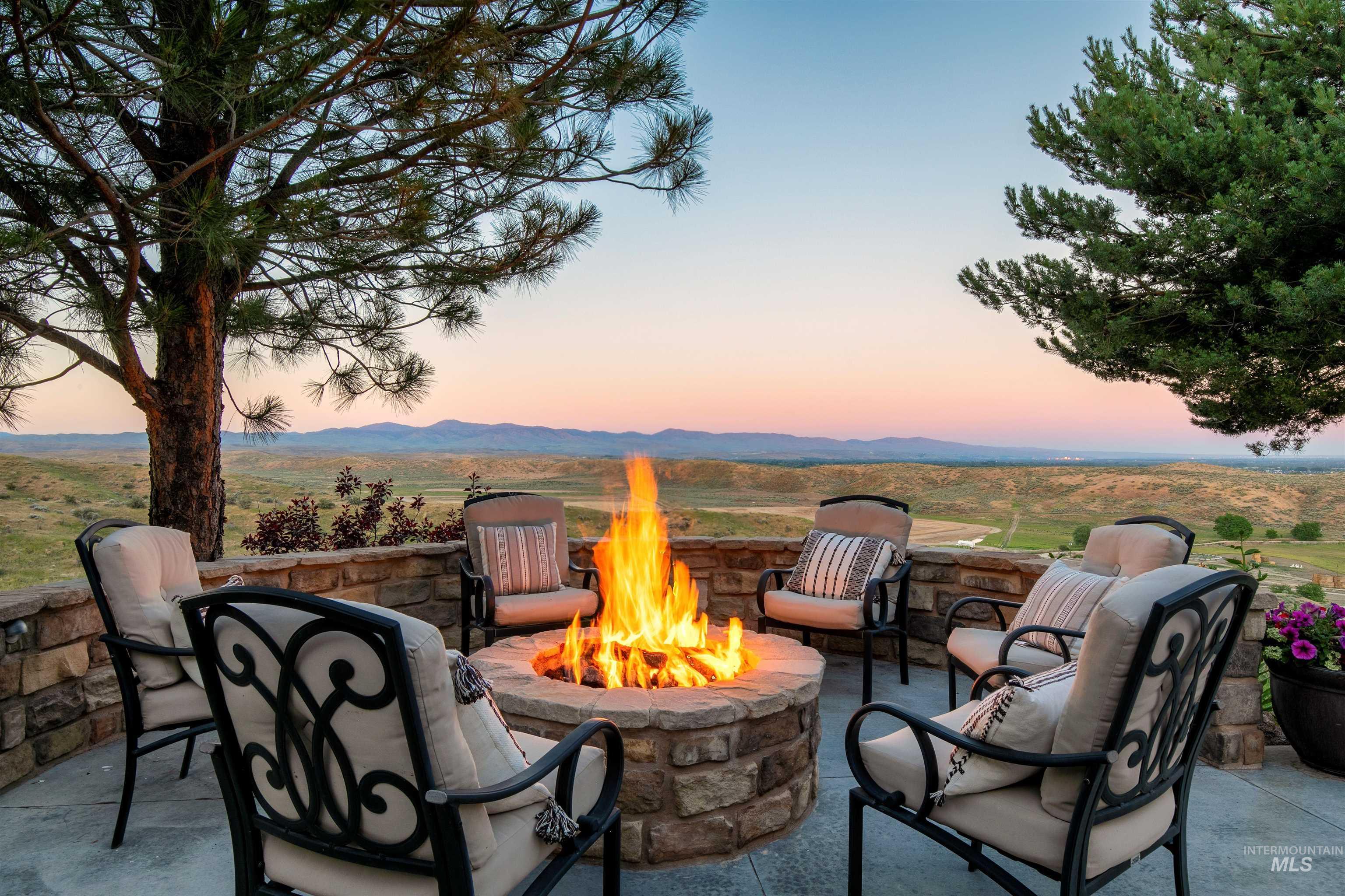Patio terrace at dusk featuring a patio and a fire pit