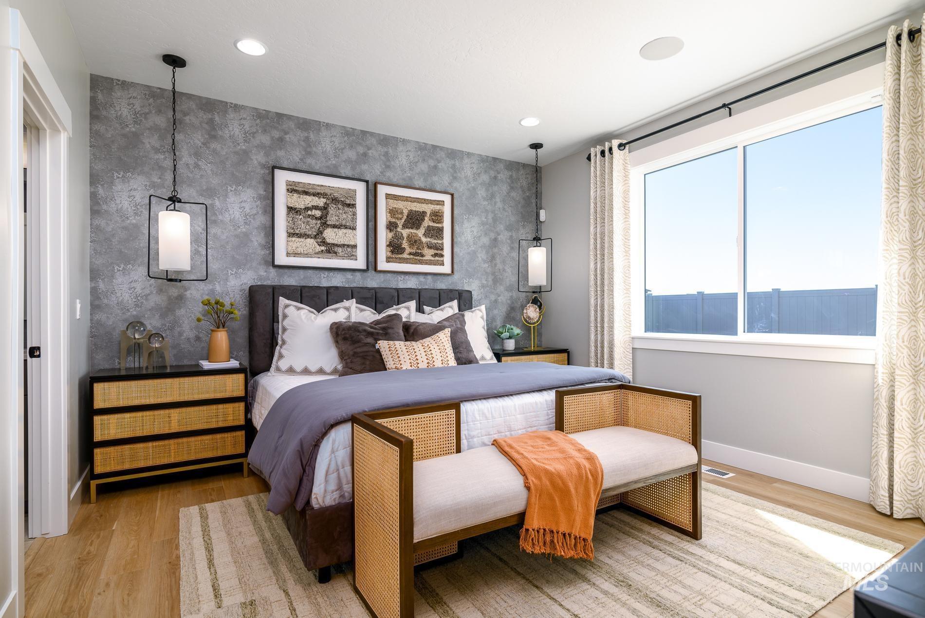 Bedroom featuring wood finished floors, an accent wall, and recessed lighting