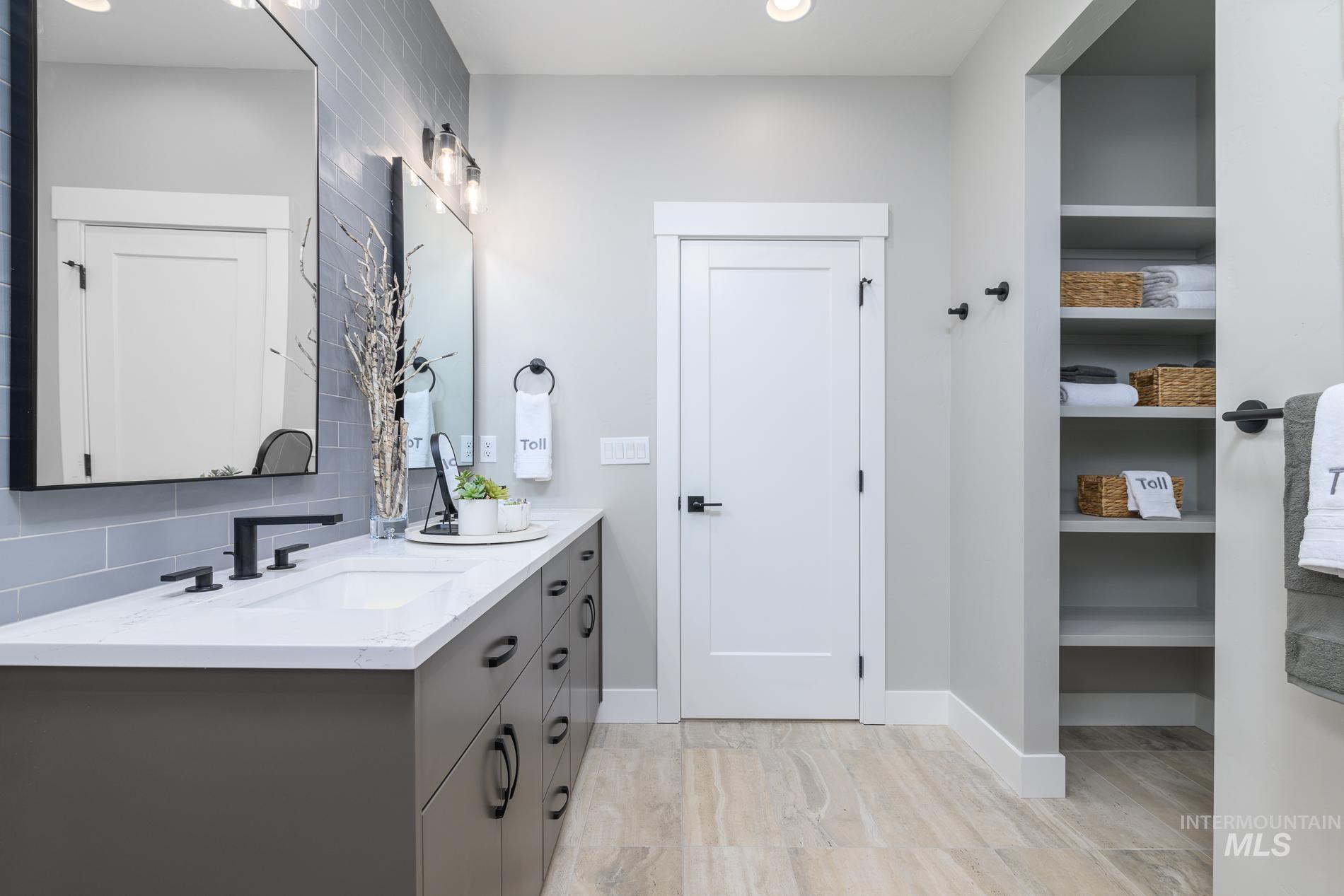 Full bathroom with backsplash, double vanity, a closet, and recessed lighting