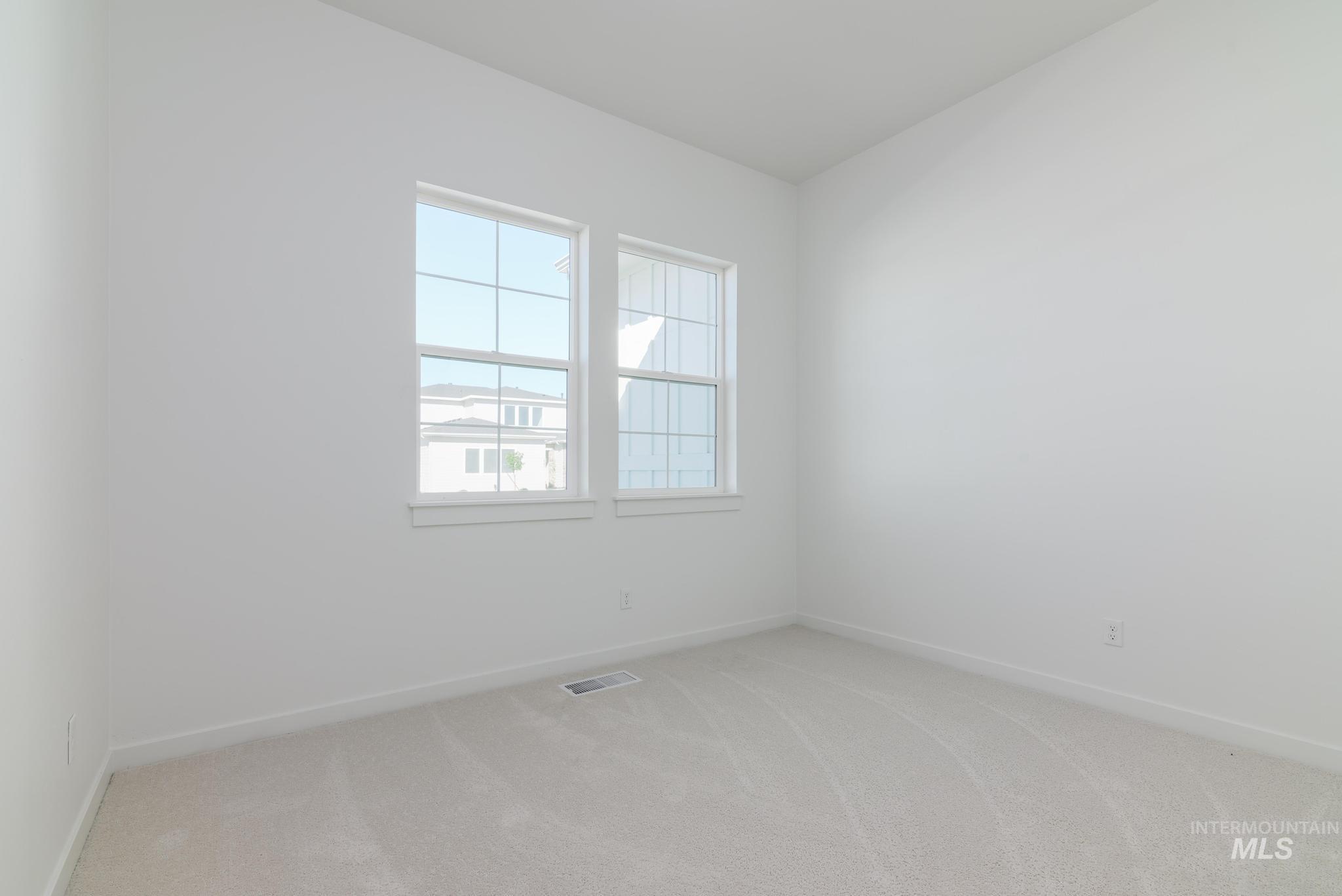 Unfurnished room featuring light colored carpet