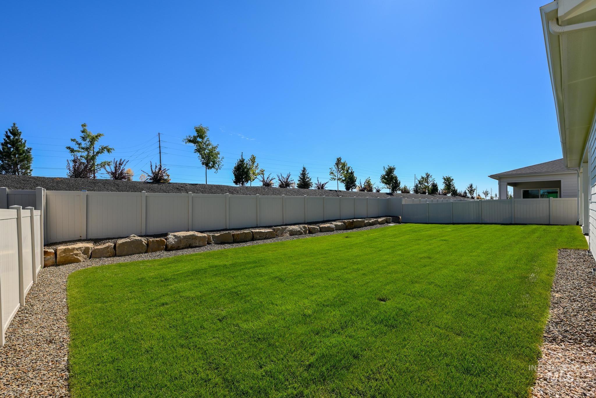 View of fenced backyard