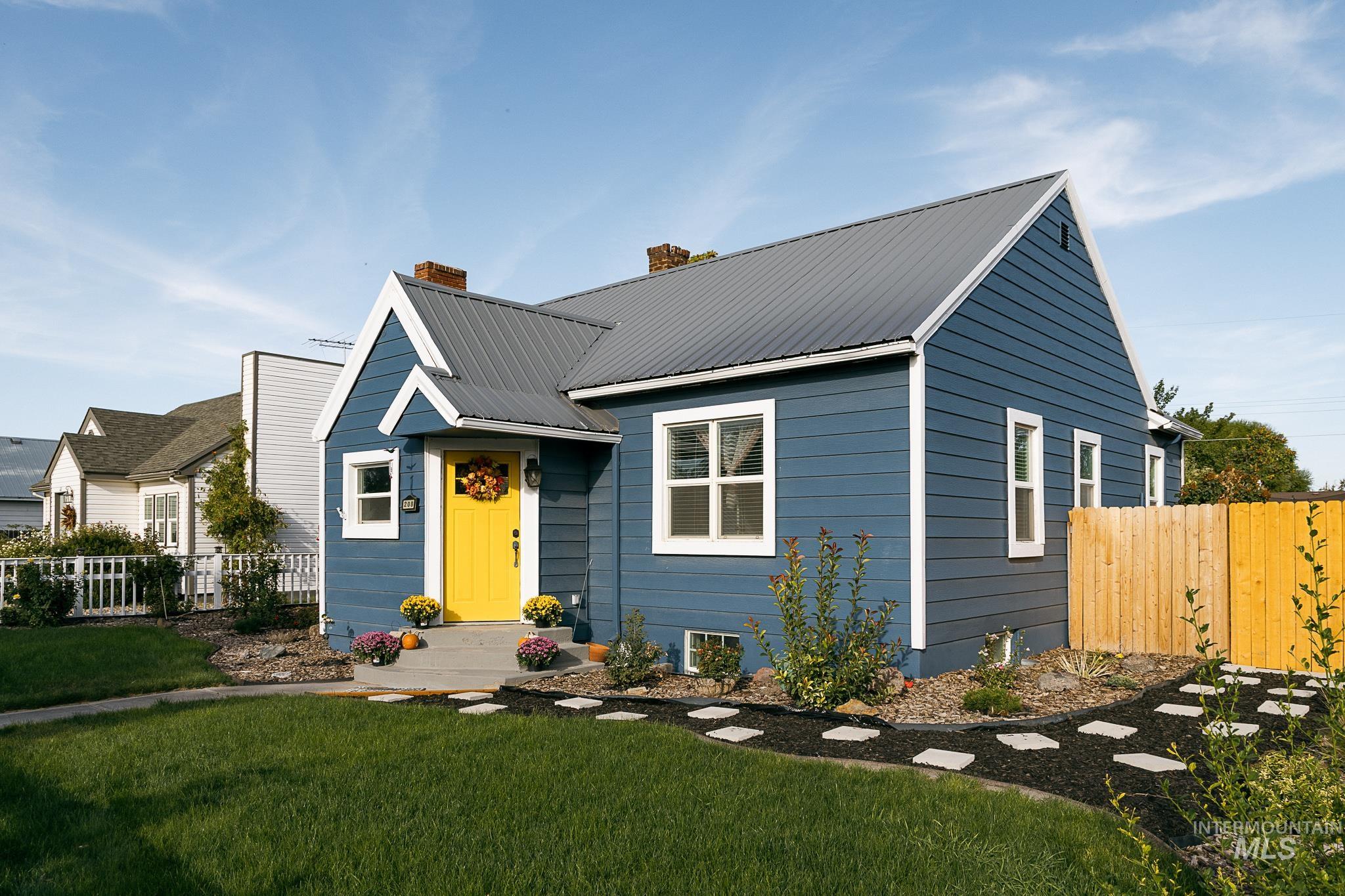 Bungalow-style house featuring a metal roof