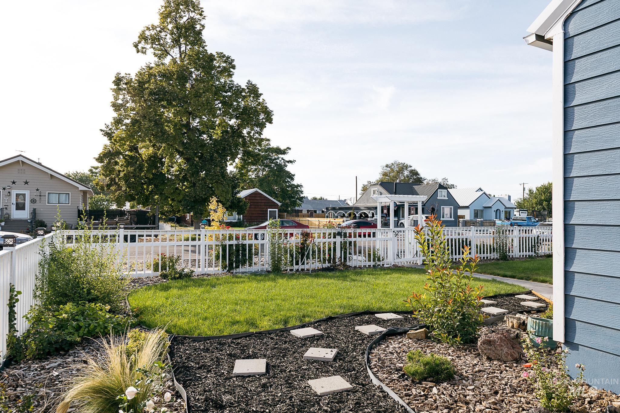 Fenced backyard featuring a residential view