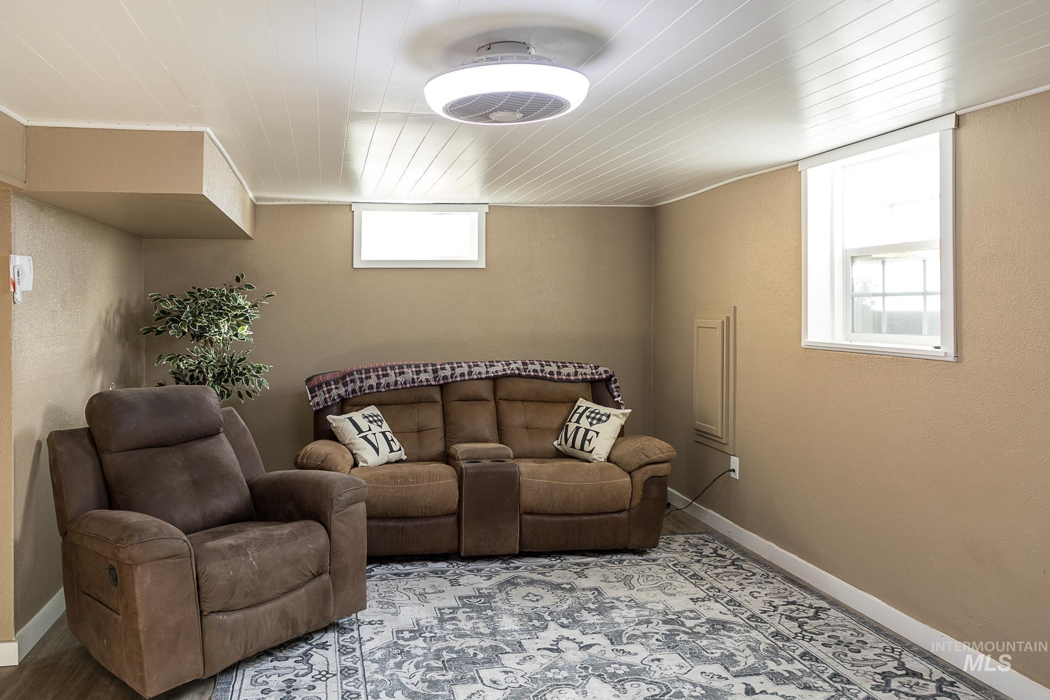 Living room featuring baseboards and wood ceiling