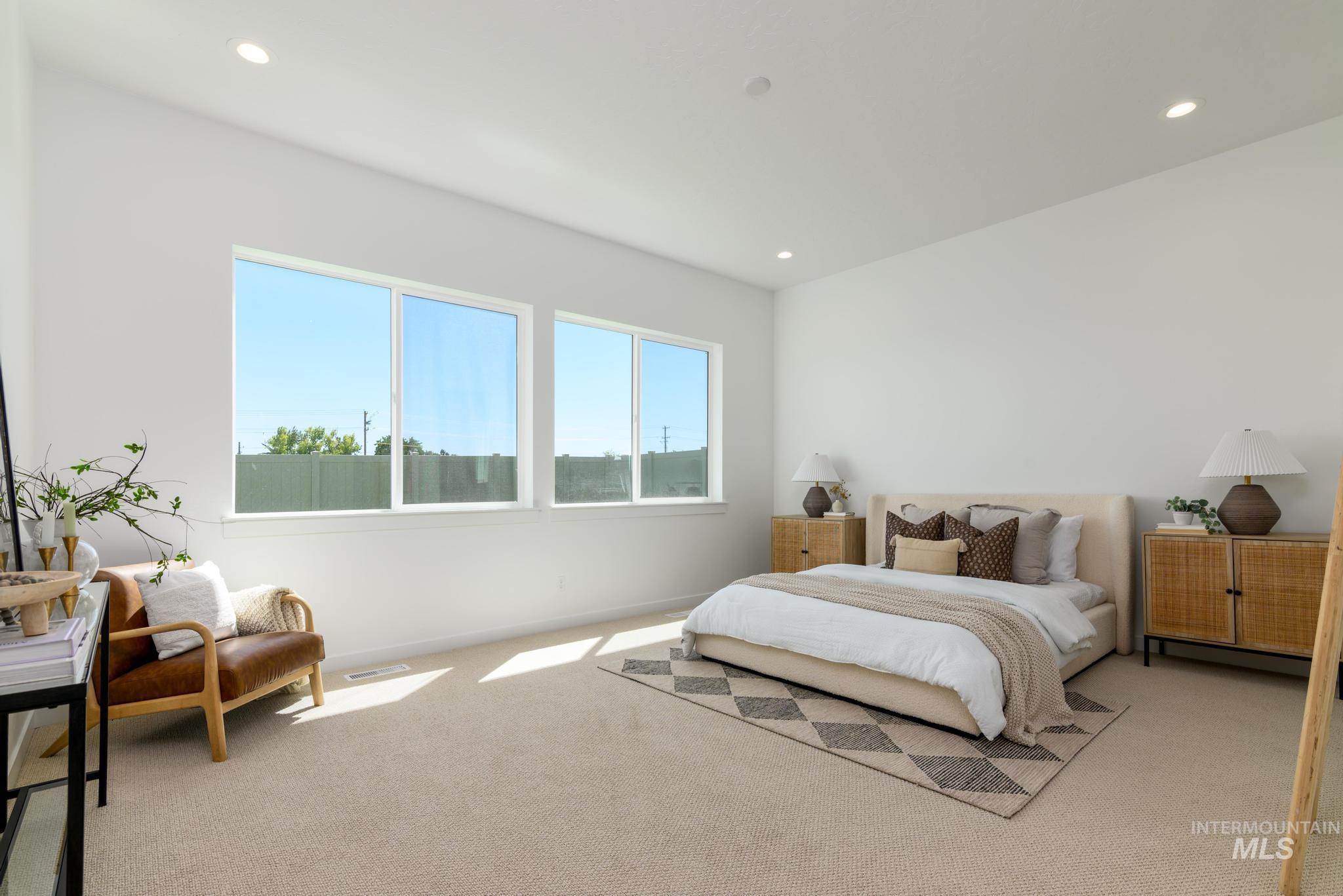 Carpeted bedroom with recessed lighting and baseboards