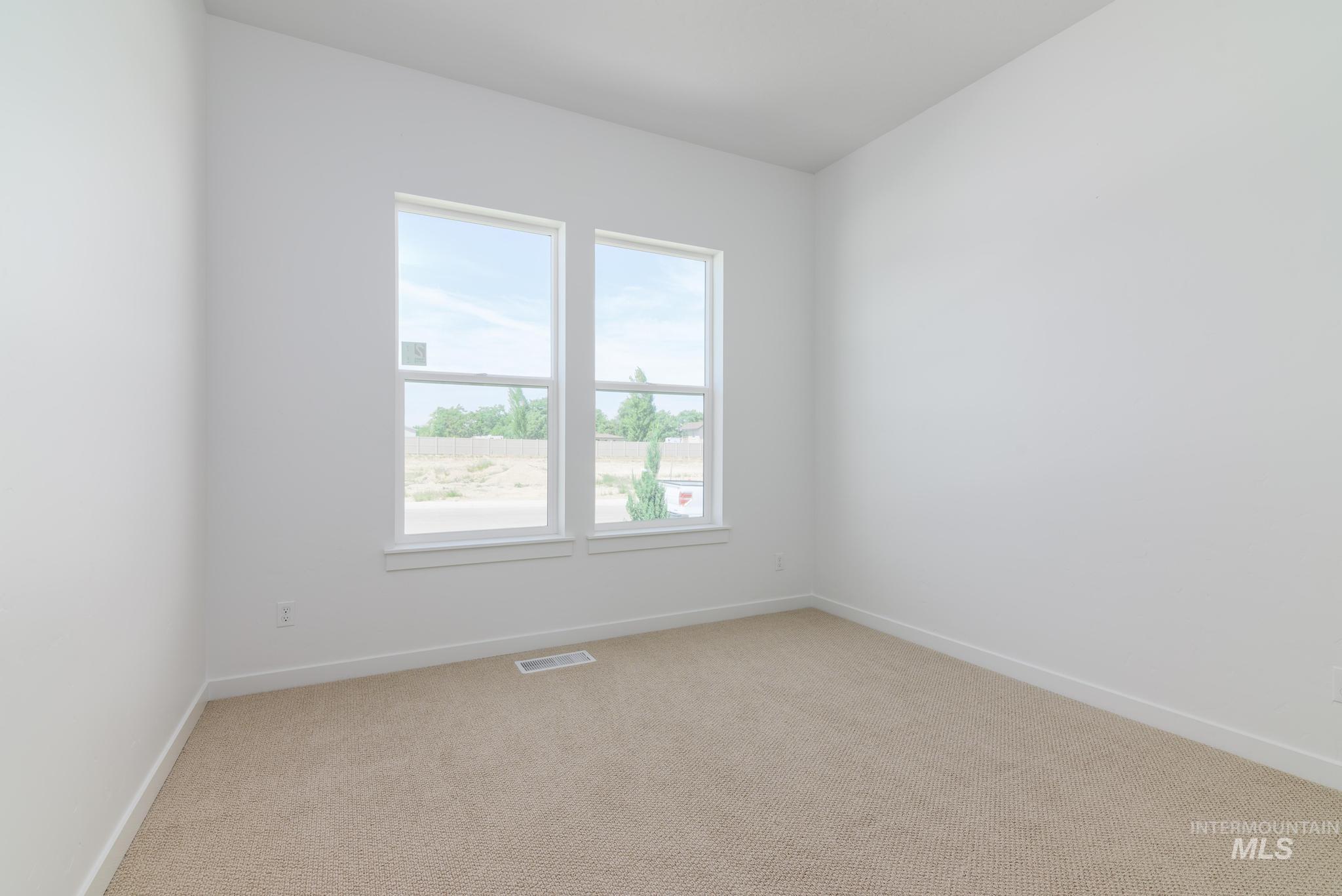 Unfurnished room with light carpet and baseboards