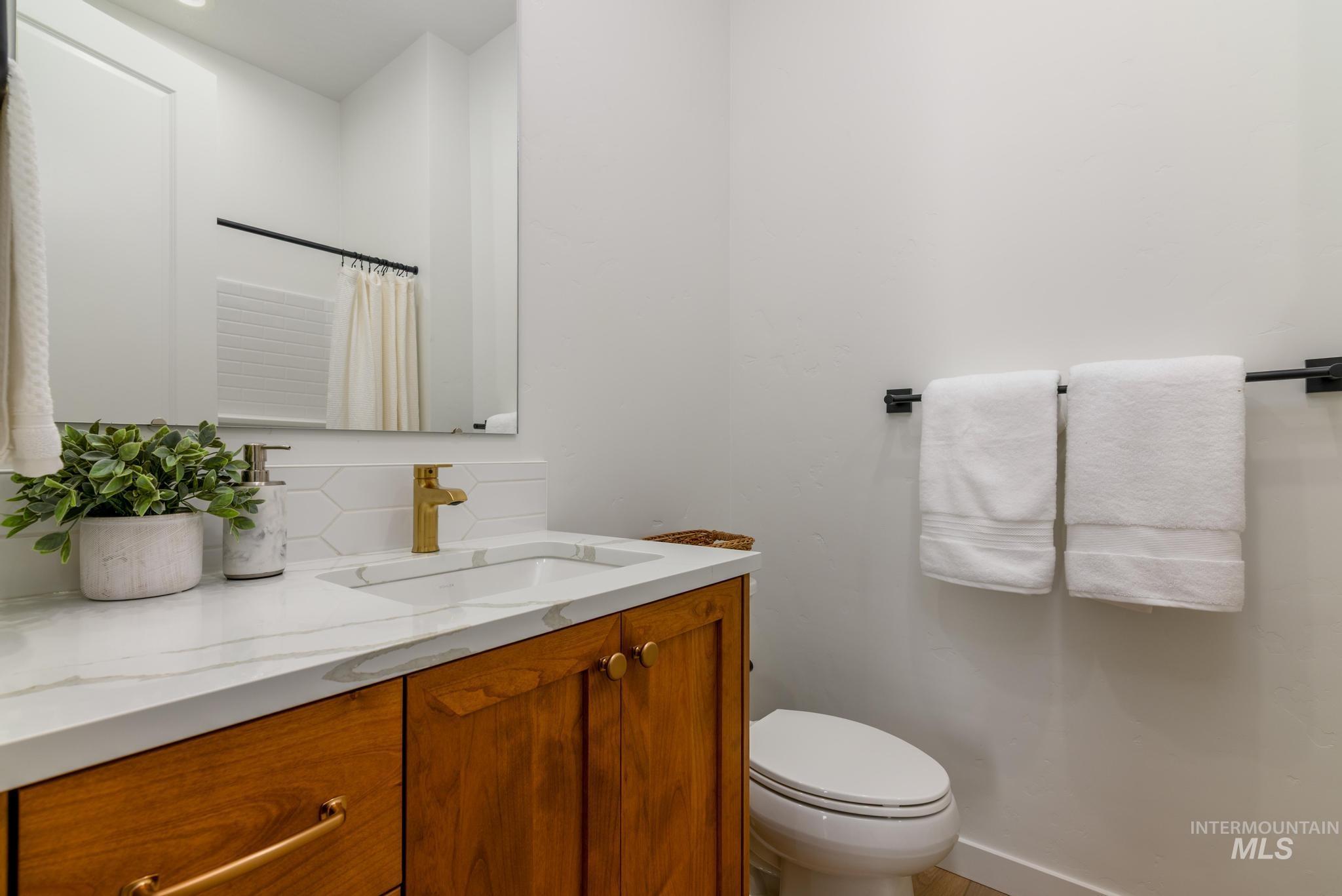 Bathroom with vanity and curtained shower