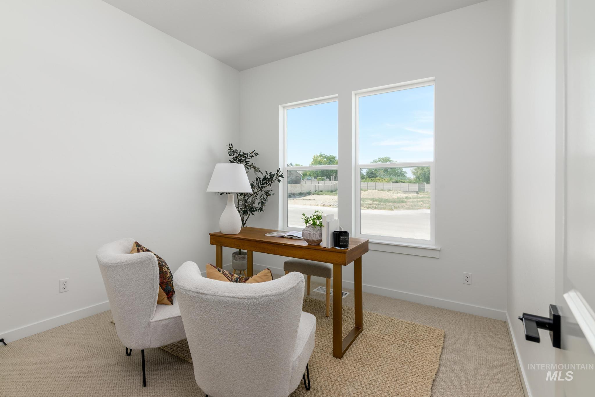 Office space featuring light colored carpet and baseboards