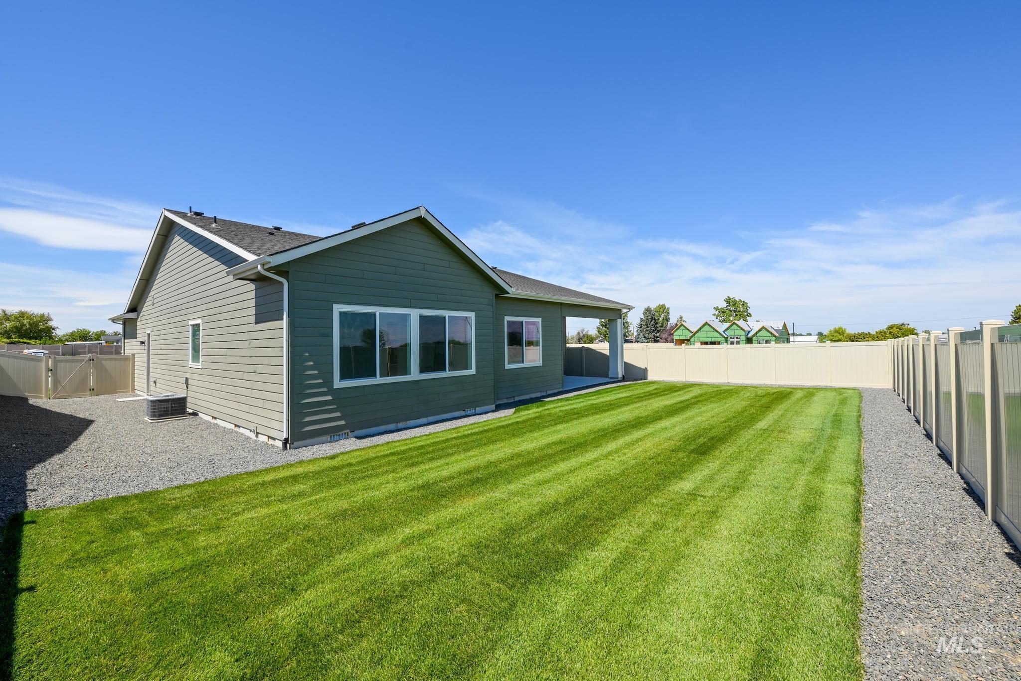 Back of property featuring a fenced backyard and a patio area