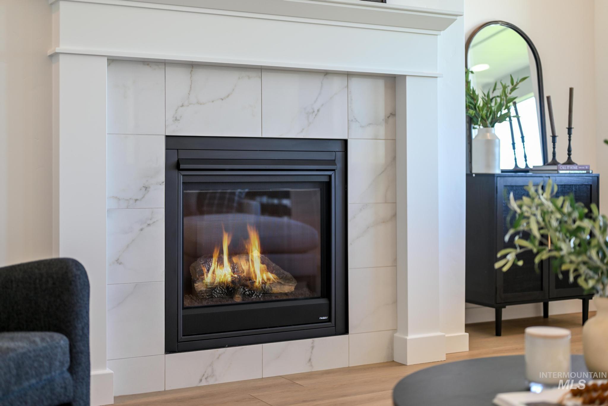 Detailed view of wood finished floors and a fireplace