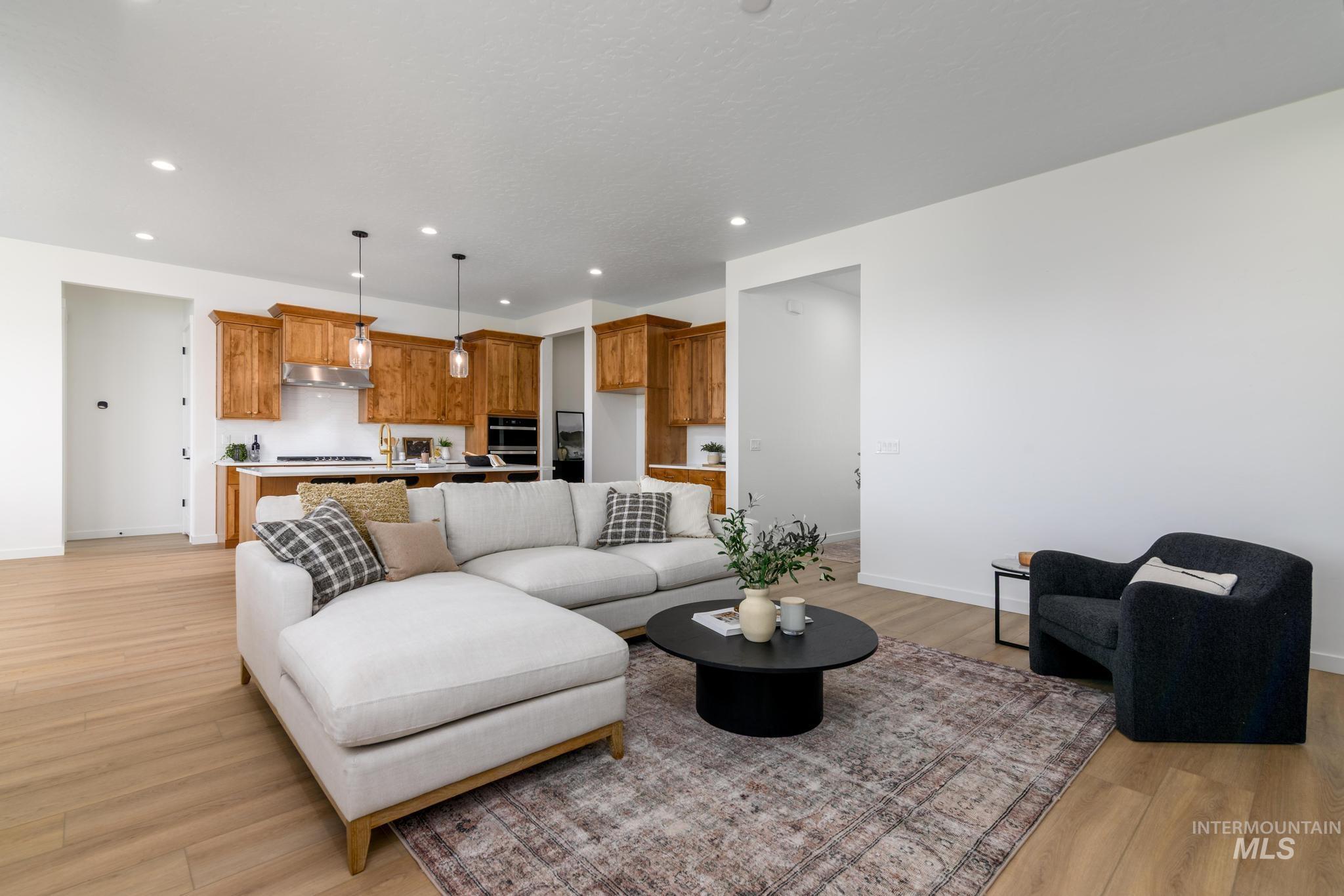 Living area with recessed lighting and light wood-type flooring