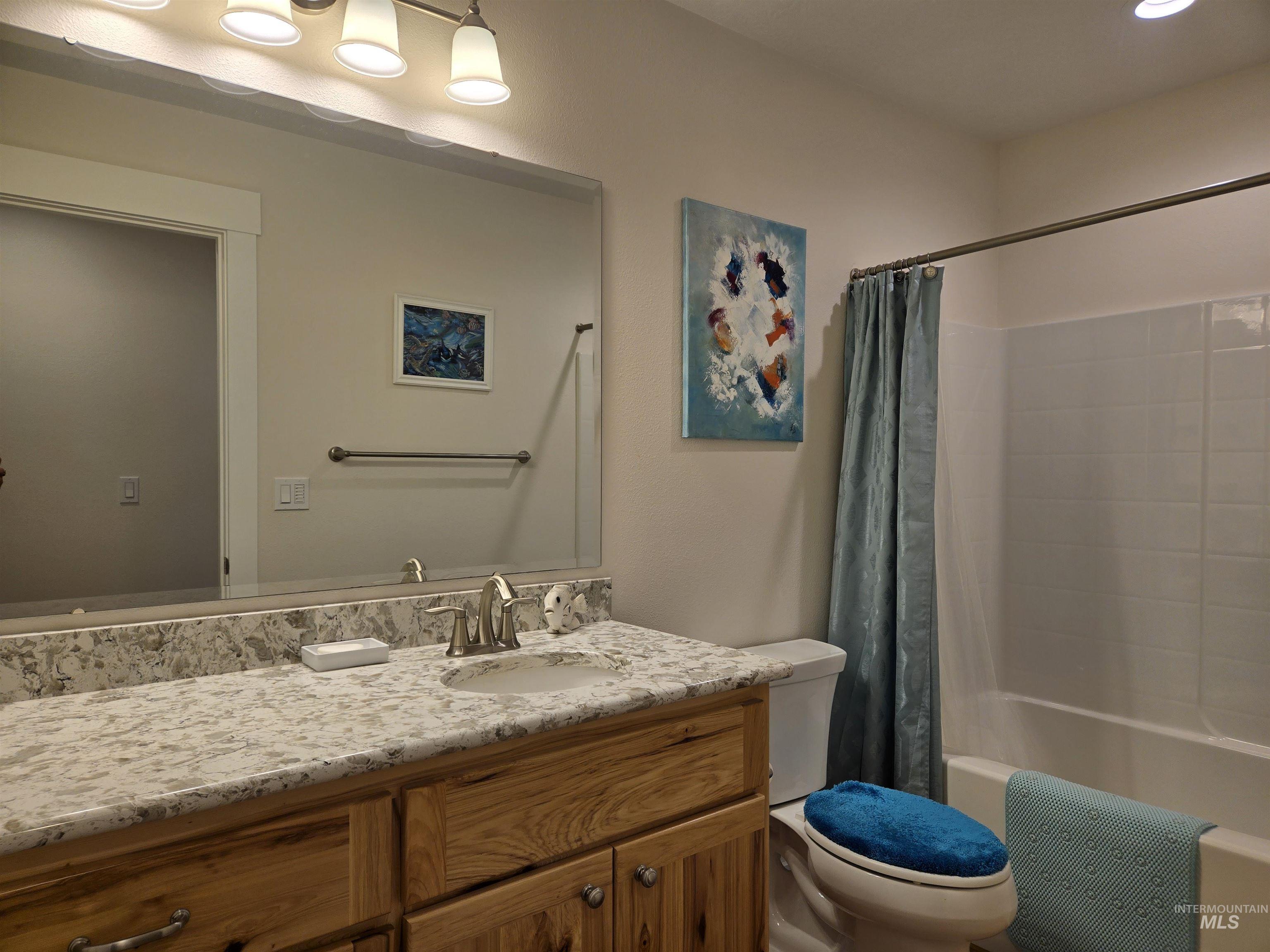 Bathroom featuring vanity and shower / bath combo