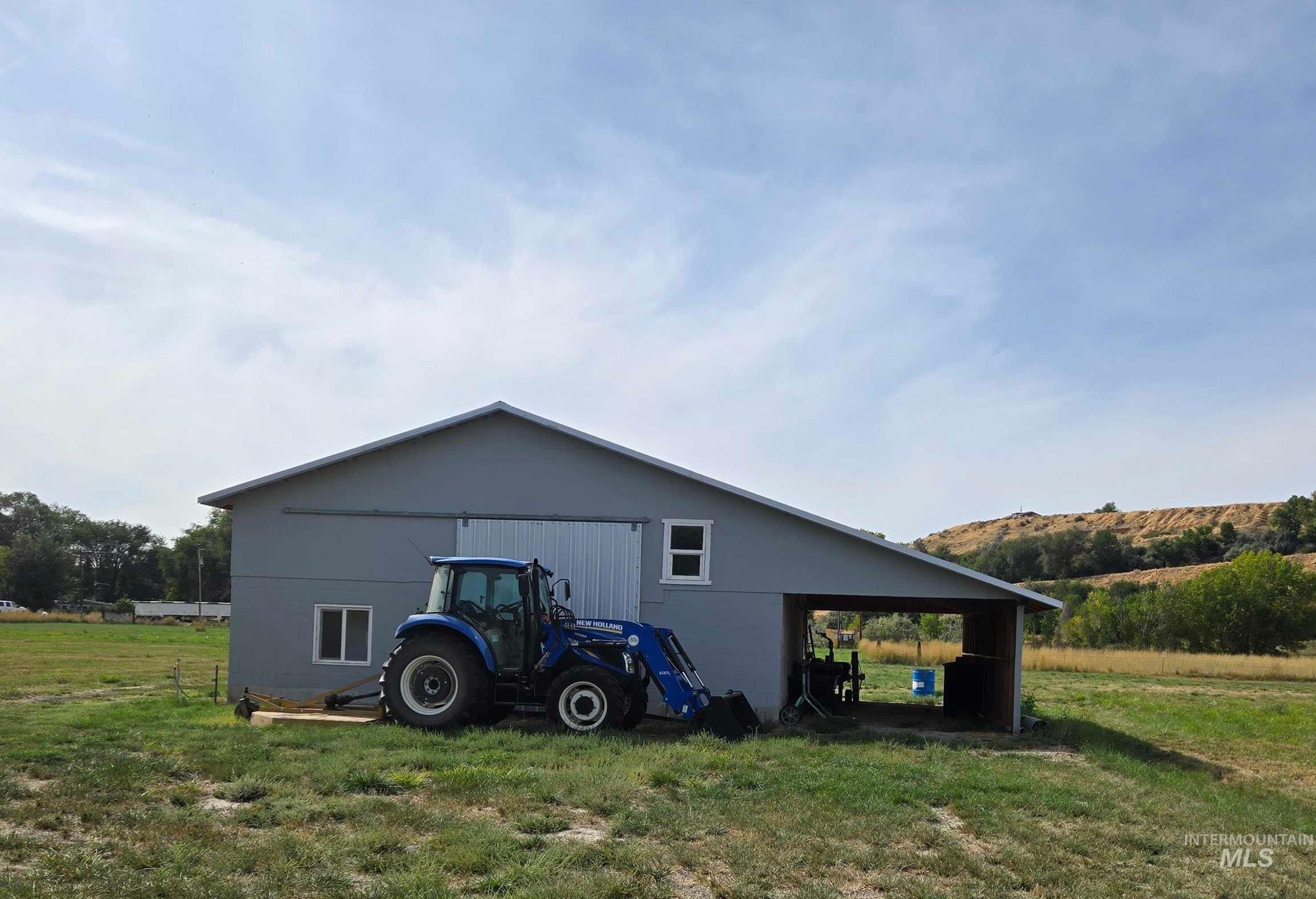 This building can be used as a shop or barn.  Has small office/ tack room area.  Is plumbed for water if needed.  Does have Electricity.  Has covered storage area next to the building and the doors into the barn/ shop are drive through.