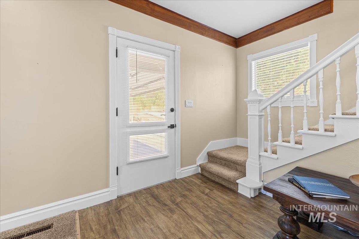 Doorway with stairway and hard floors.