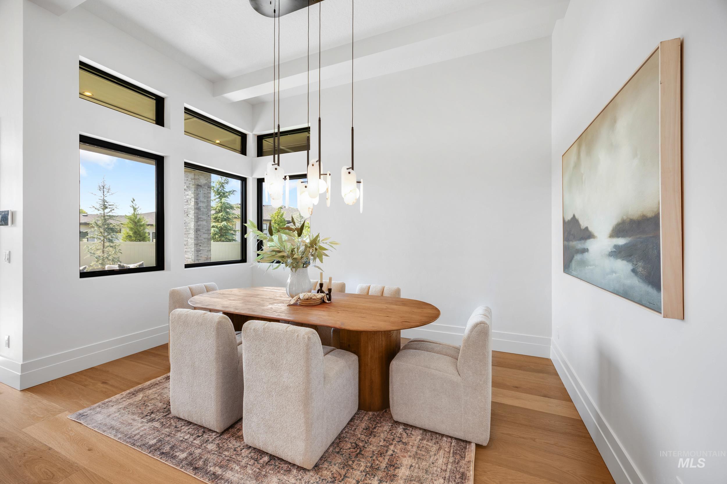 Dining area with light wood finished floors and baseboards