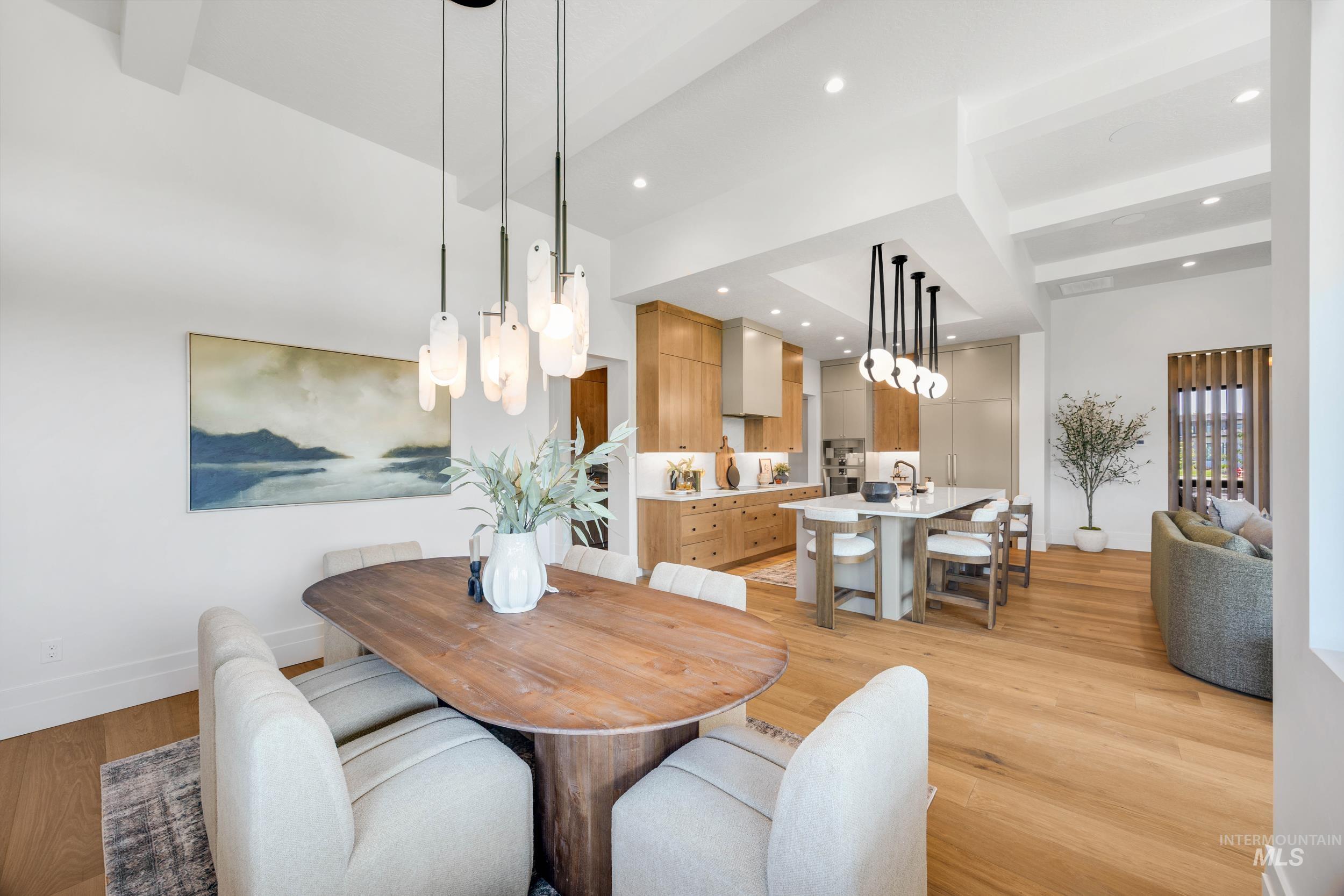 Dining area featuring beamed ceiling, light wood-type flooring, and recessed lighting