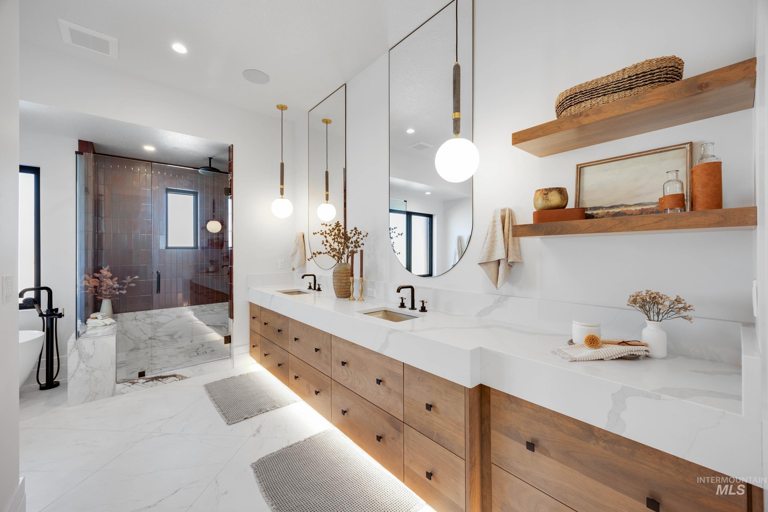 Bathroom with a shower stall, light marble finish flooring, double vanity, a soaking tub, and recessed lighting