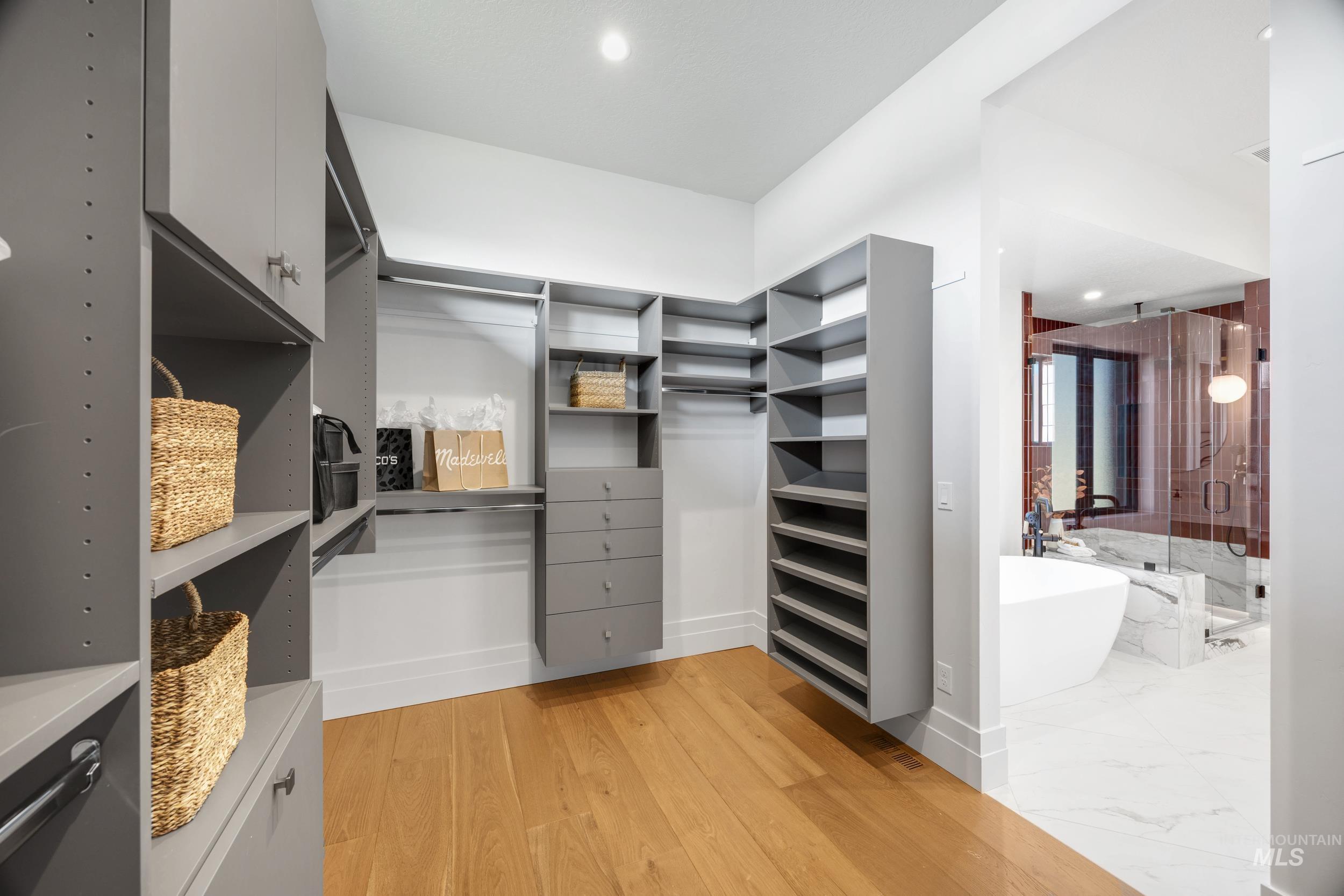 Spacious closet with light wood-type flooring
