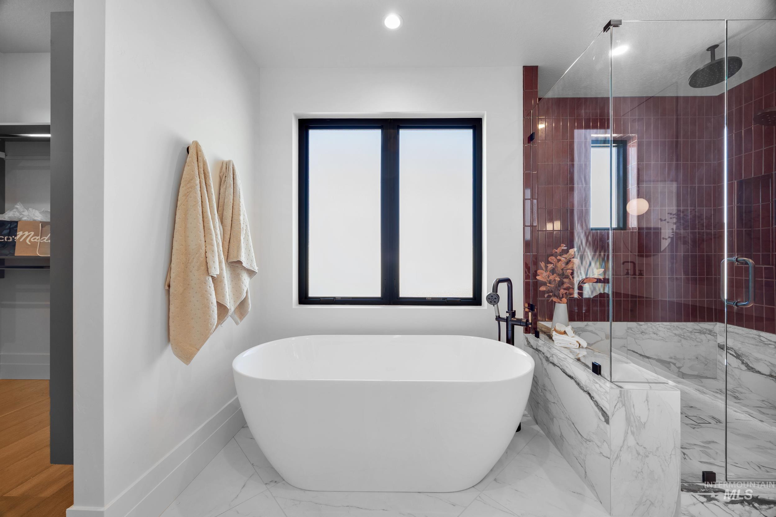 Bathroom with a marble finish shower, a soaking tub, marble finish floors, and recessed lighting
