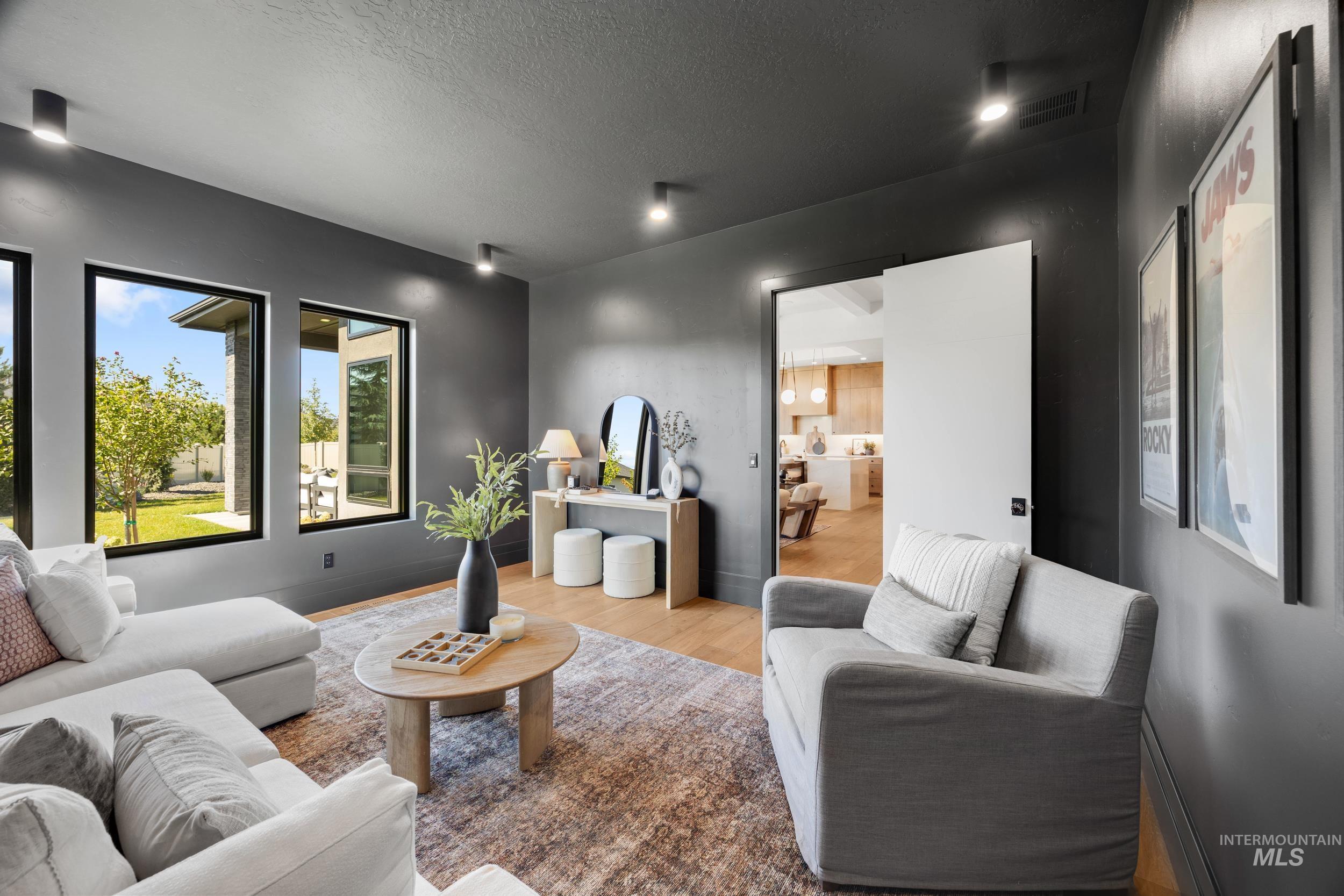 Living area featuring a textured ceiling and light wood-type flooring