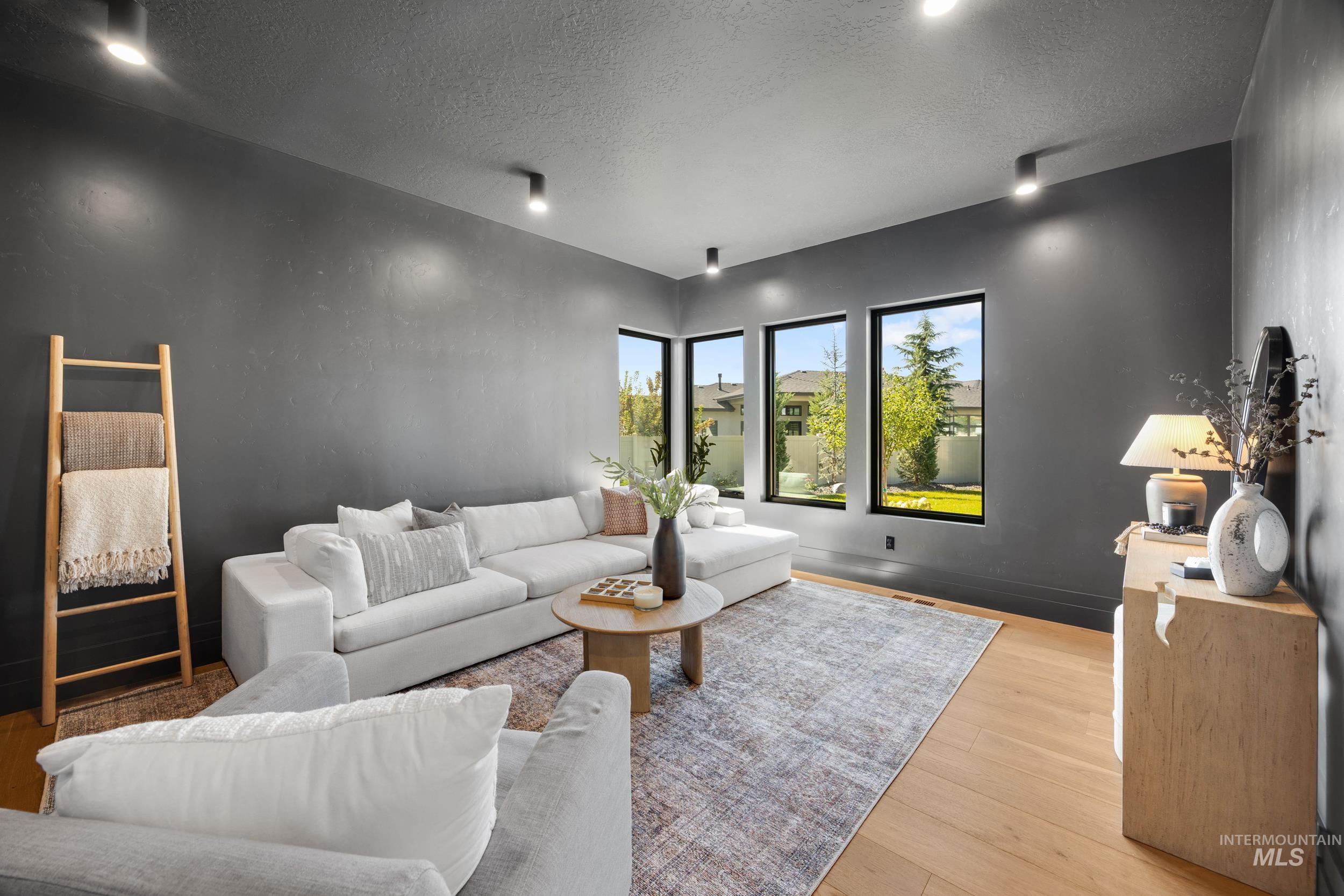 Living room with a textured ceiling and wood finished floors