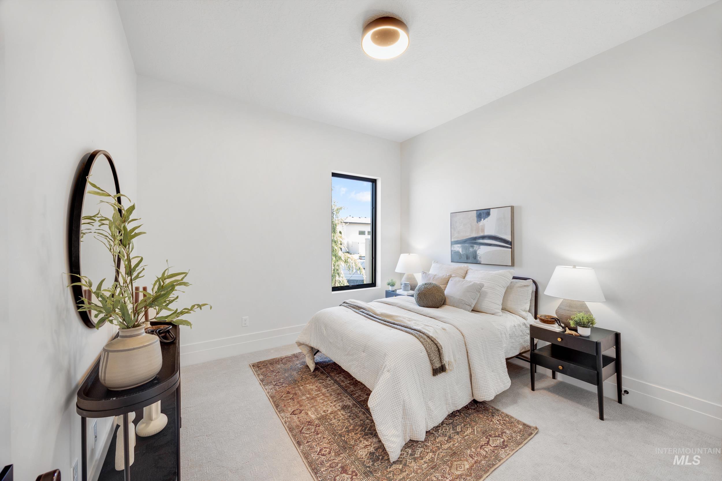 Bedroom featuring baseboards and light carpet