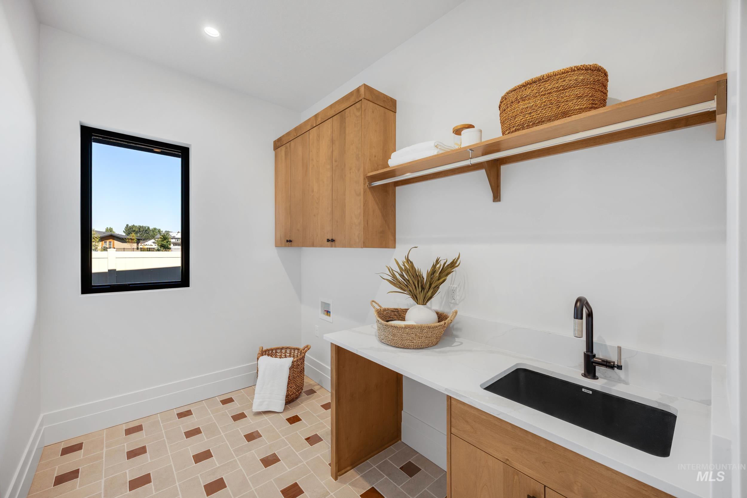 Laundry area featuring washer hookup, cabinet space, and recessed lighting