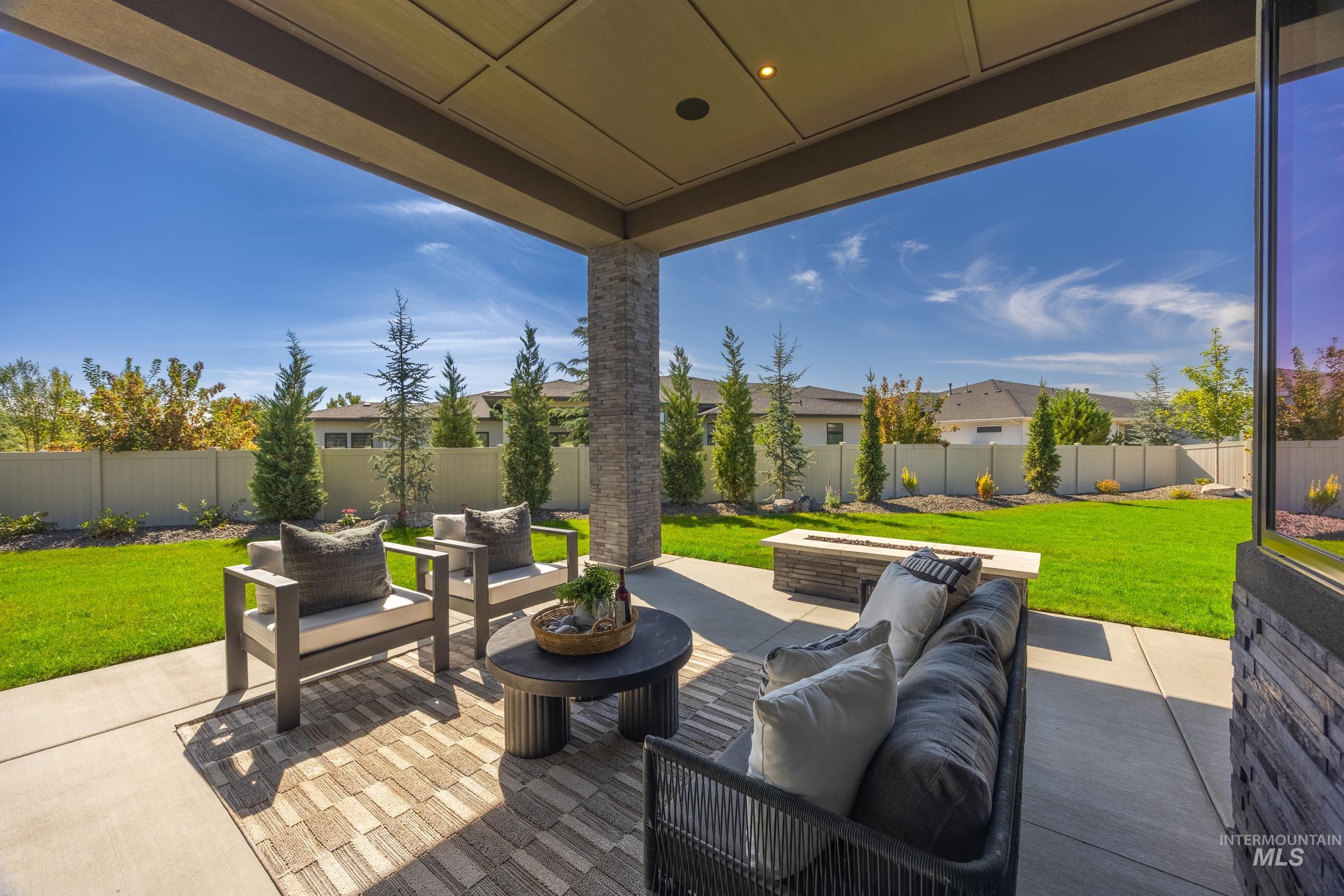 Fenced backyard with an outdoor living space and a patio area