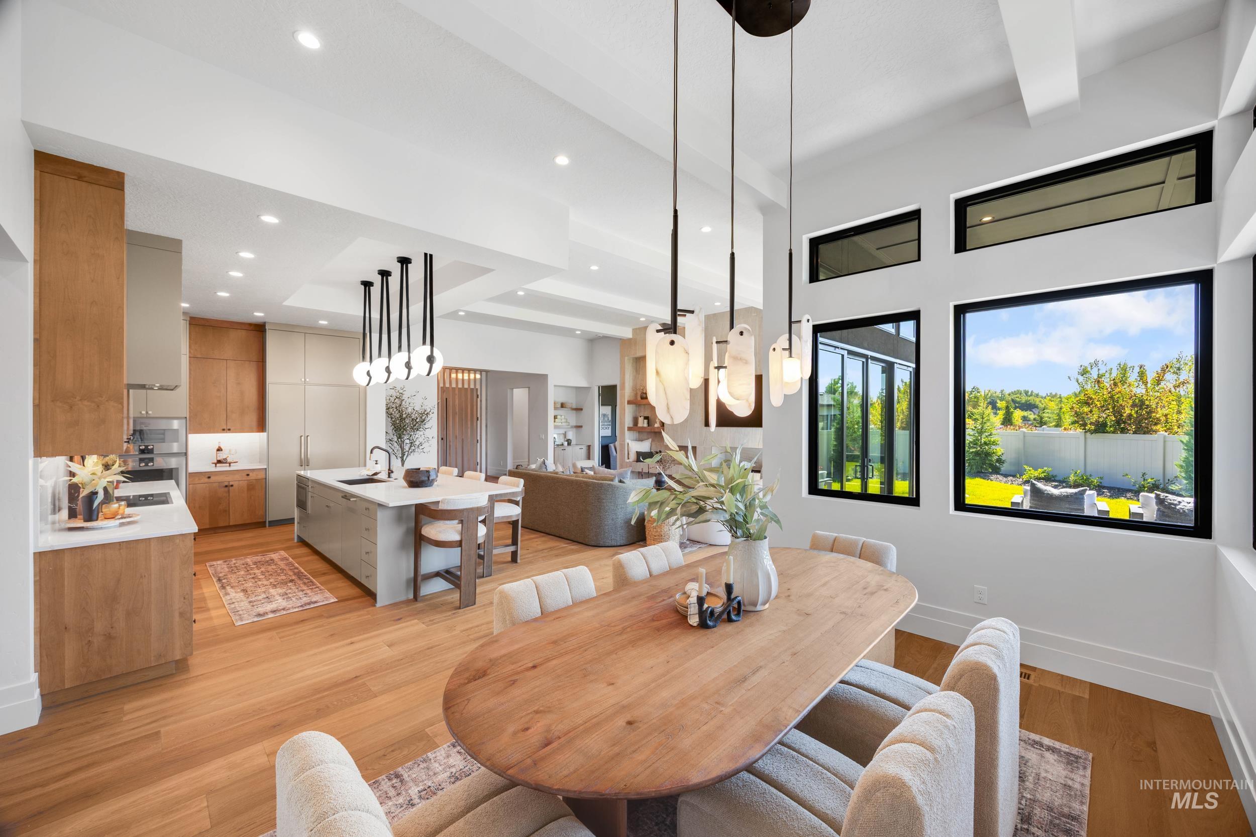 Dining room featuring light wood-style flooring, recessed lighting, and beamed ceiling