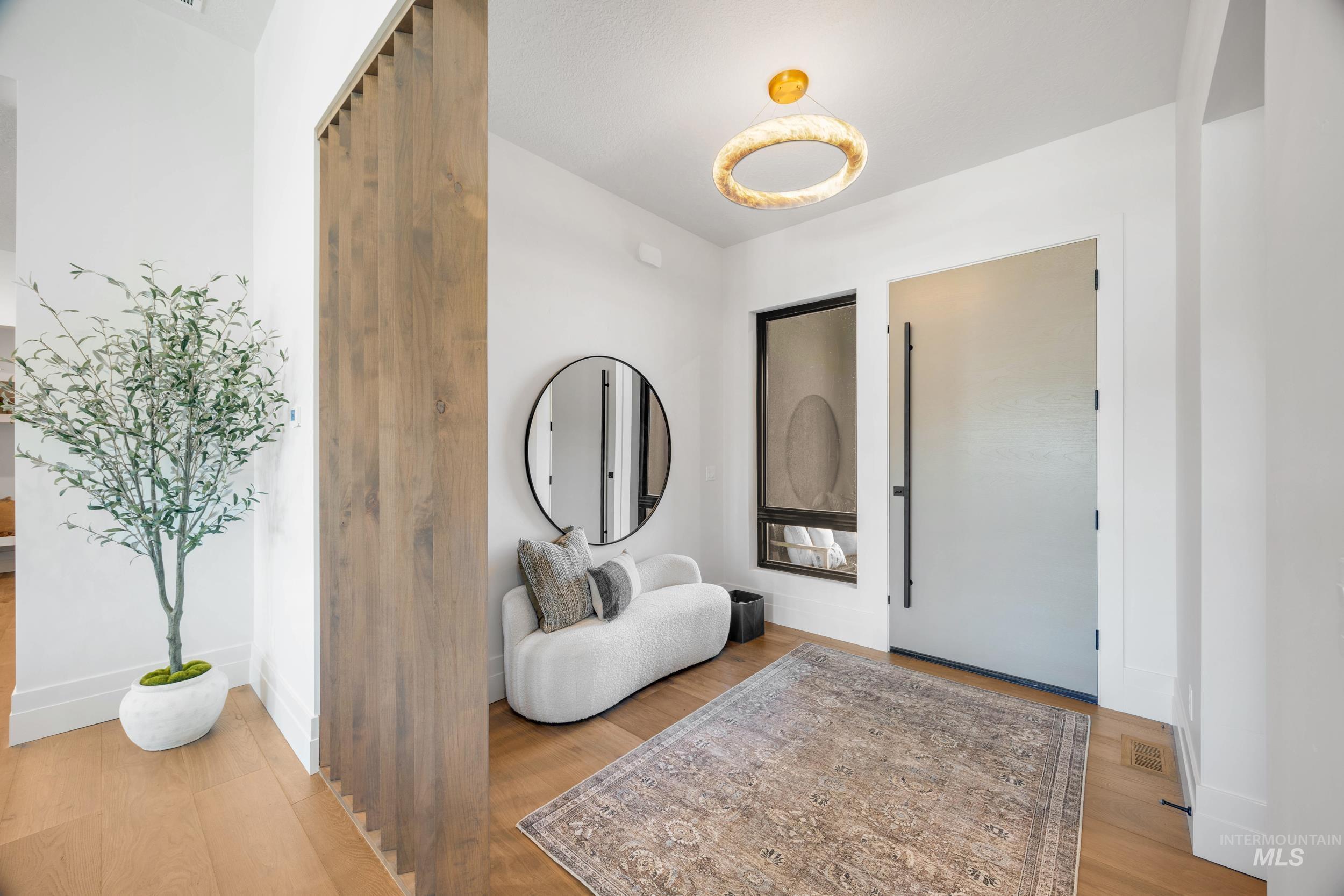 Foyer entrance with baseboards and light wood-style floors