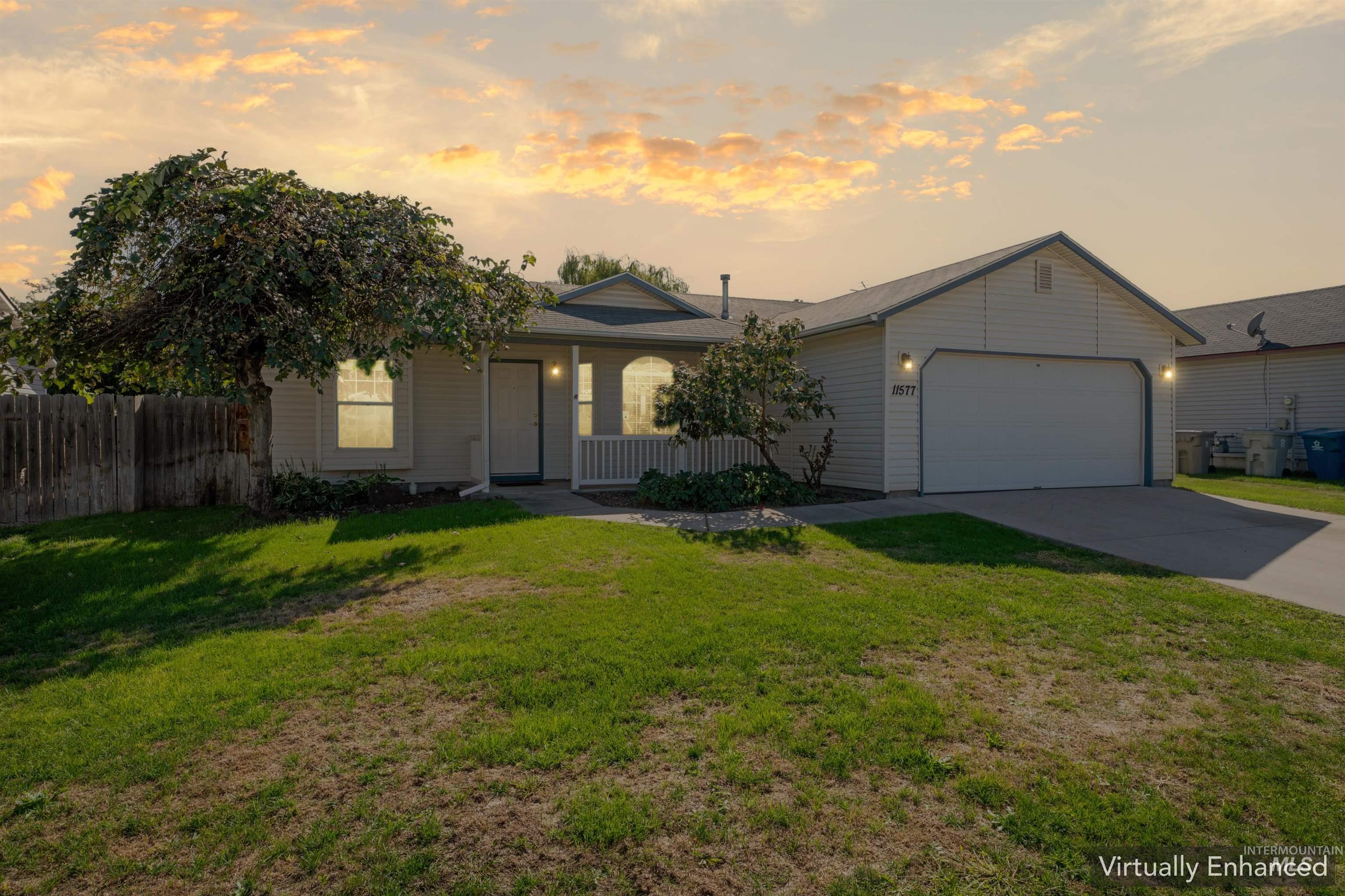 View of front of property featuring concrete driveway and an attached garage