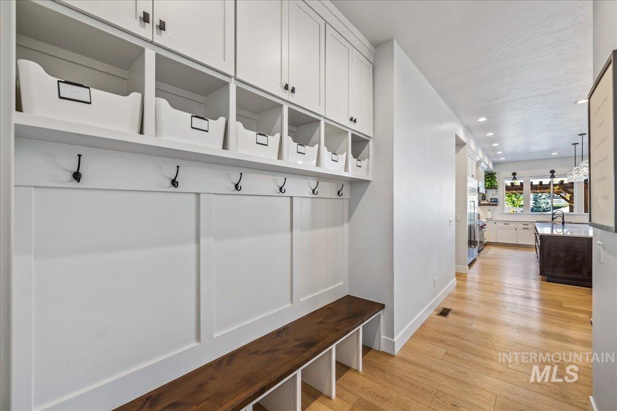 Mudroom with light wood-style flooring and recessed lighting