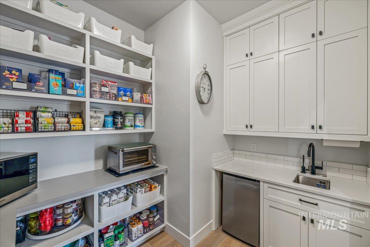 Pantry featuring a sink