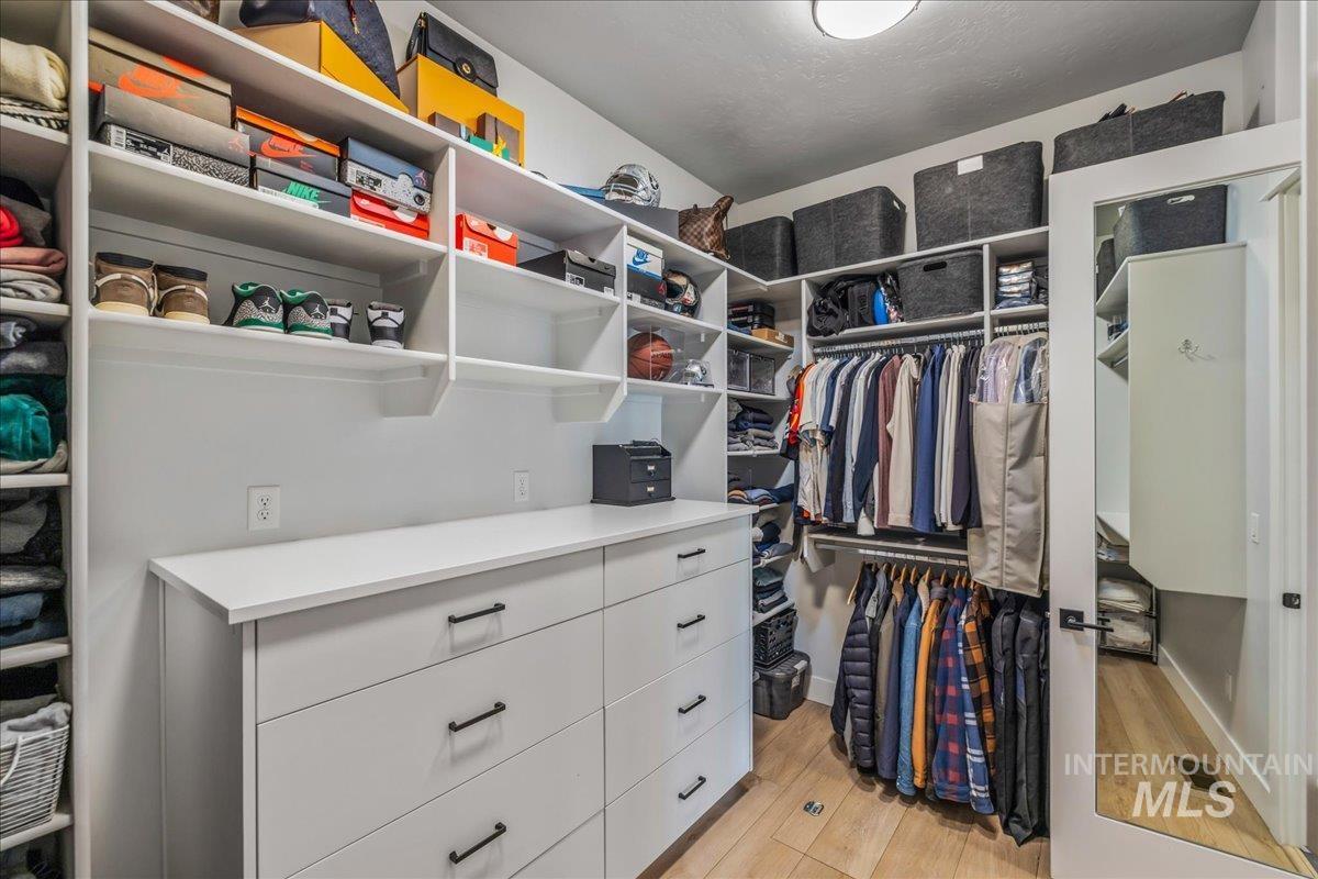 Spacious closet with light wood-style floors