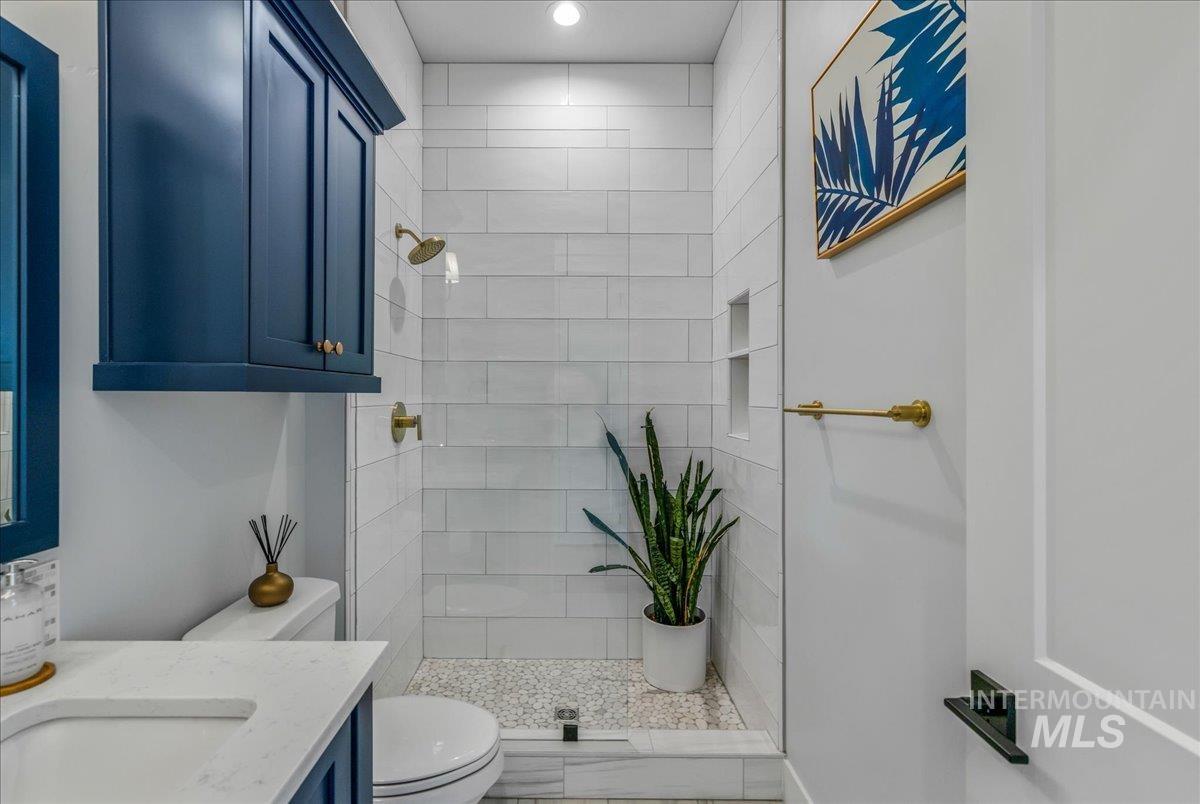 Full bath with vanity and a shower stall