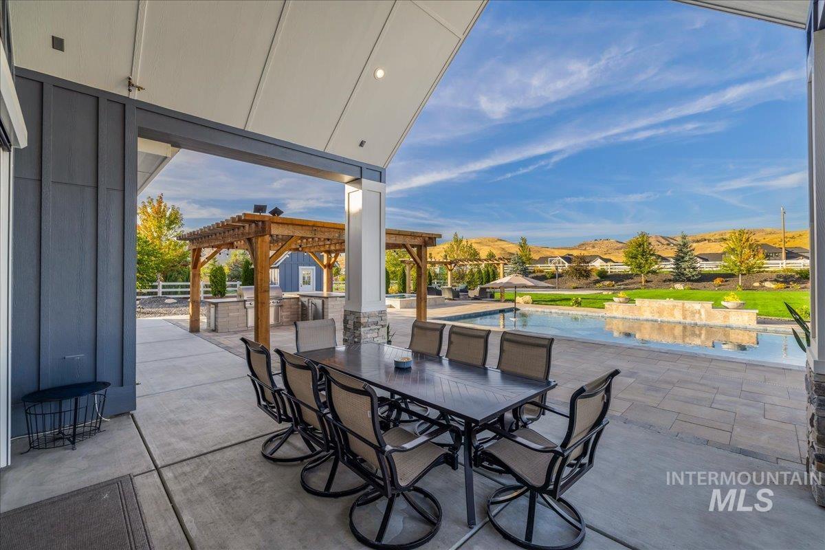 View of patio with an outdoor pool, outdoor dining space, and a pergola