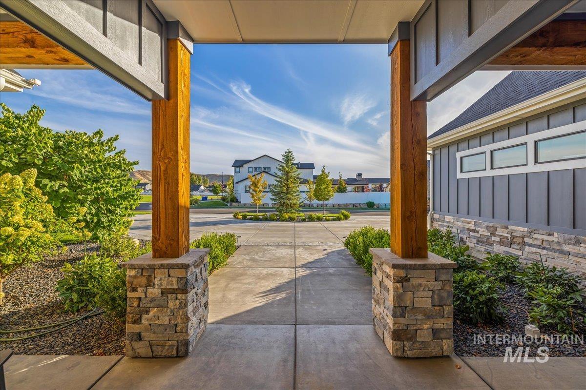 Covered porch featuring a residential view