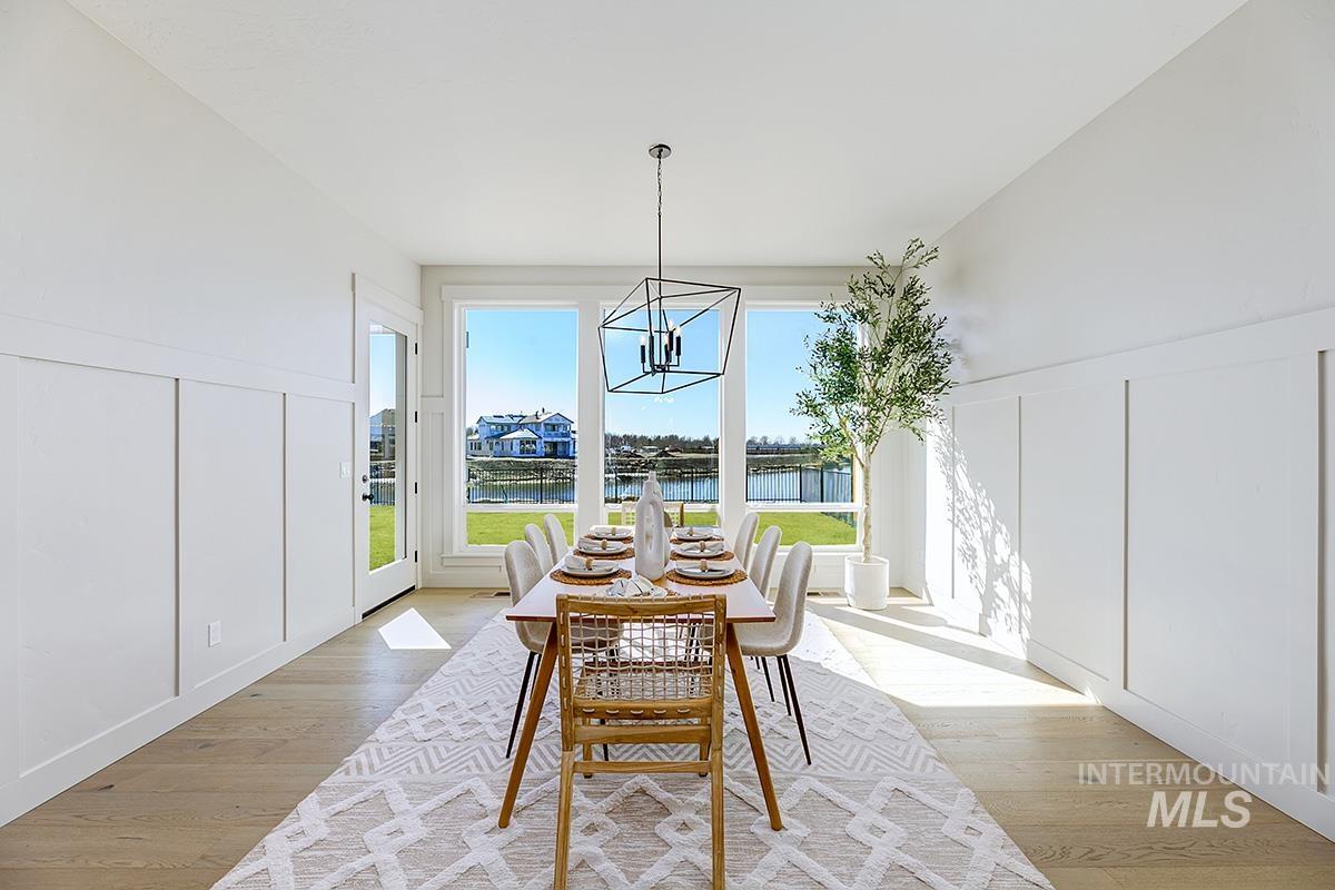 Sunroom featuring a chandelier and a water view
