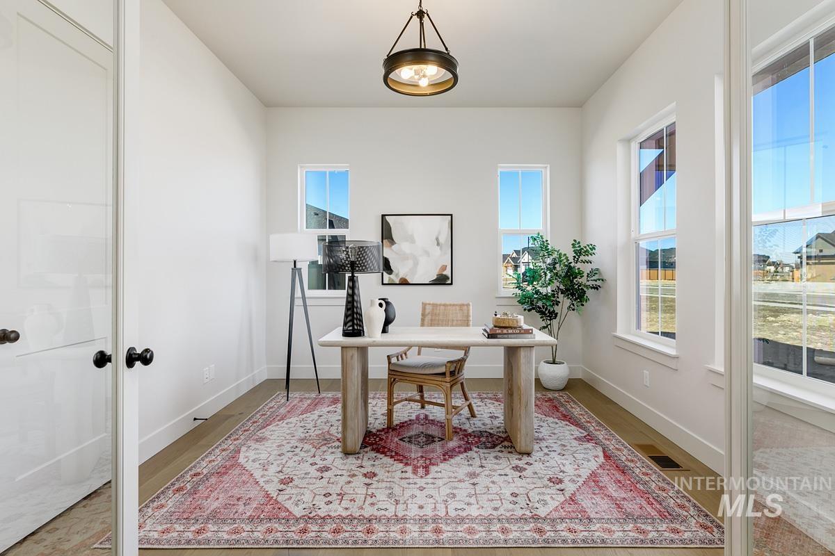 Office space with wood finished floors and baseboards