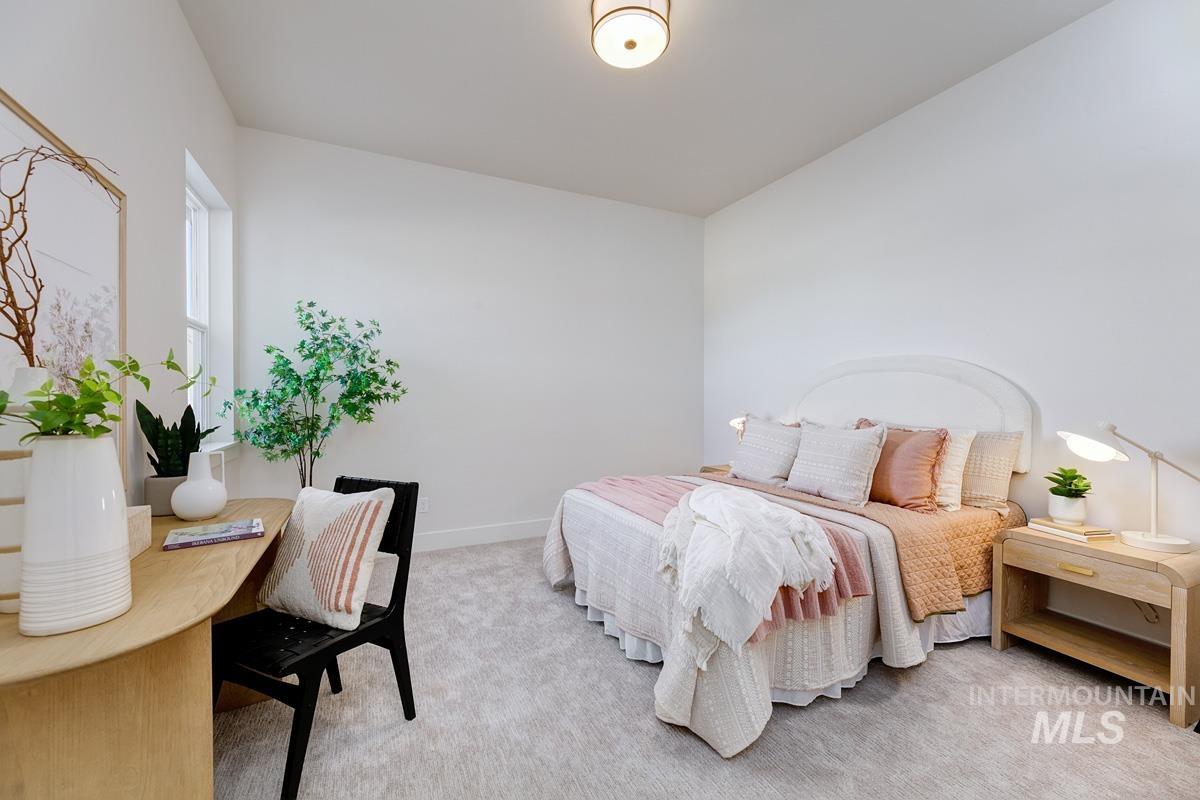 Bedroom with light carpet and baseboards