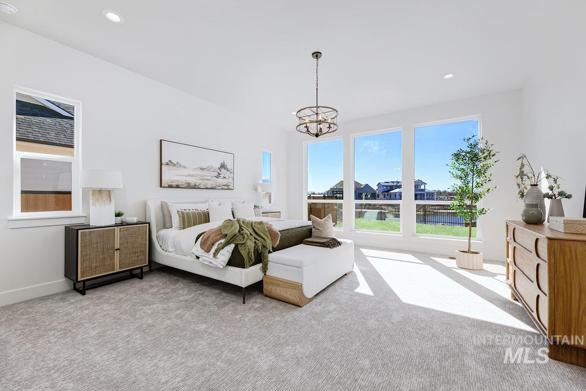 Bedroom featuring carpet floors, recessed lighting, and a chandelier