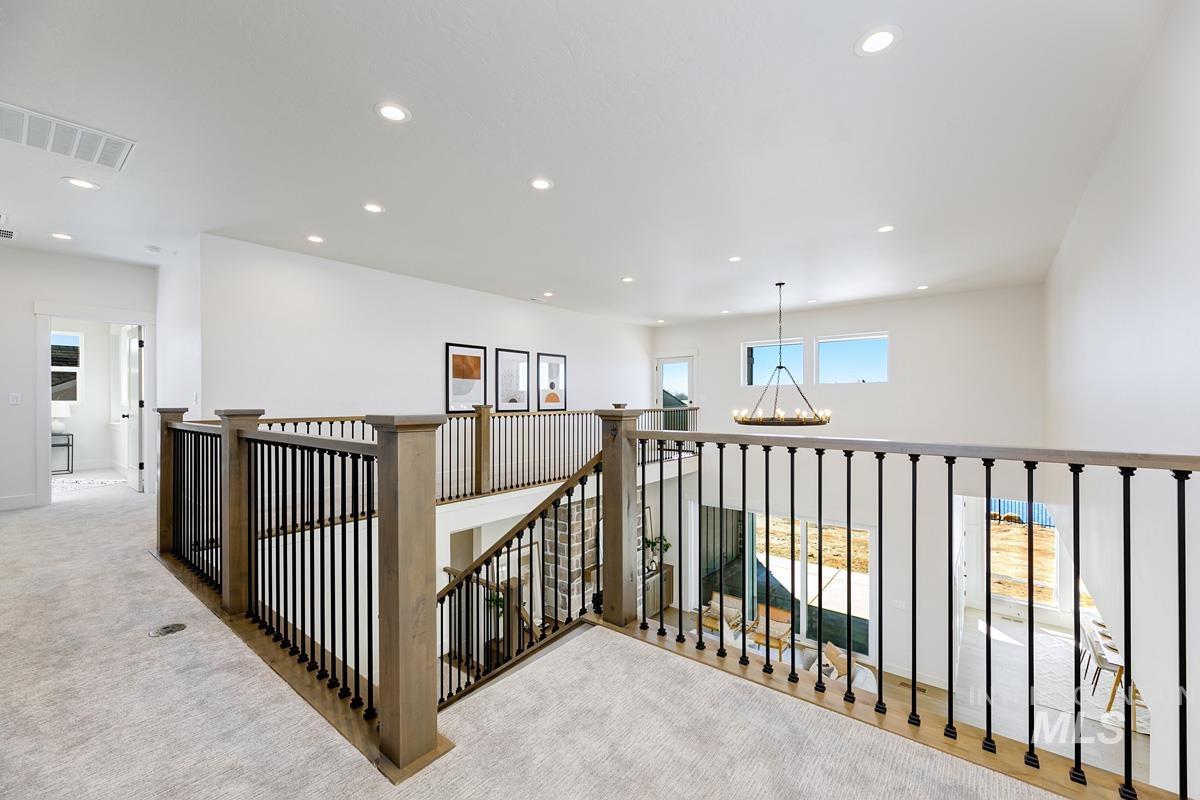 Corridor featuring recessed lighting, carpet flooring, a chandelier, and an upstairs landing