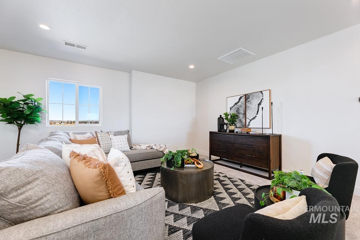 Carpeted living room with recessed lighting
