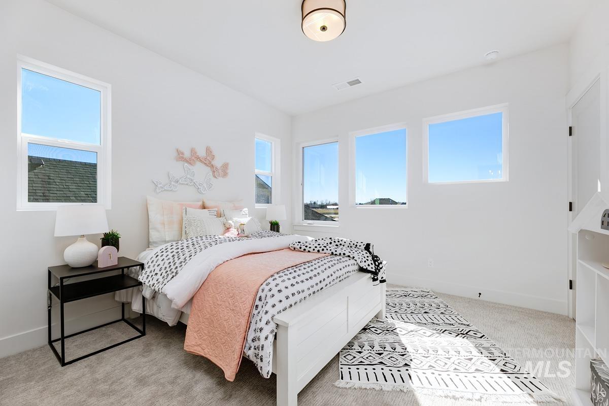 Bedroom with light carpet and baseboards