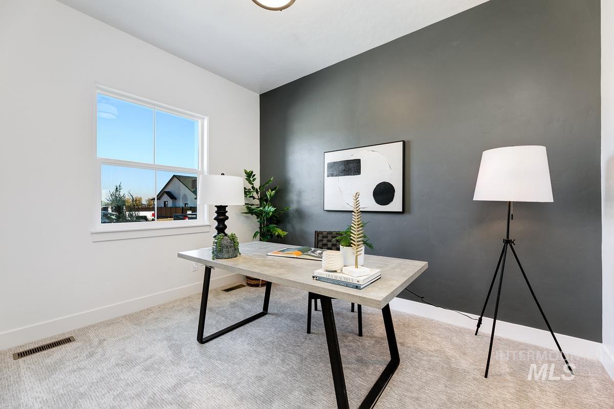 Home office featuring baseboards and light colored carpet