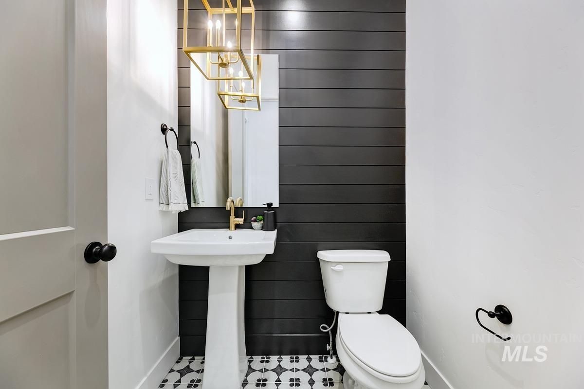Half bath featuring toilet and baseboards